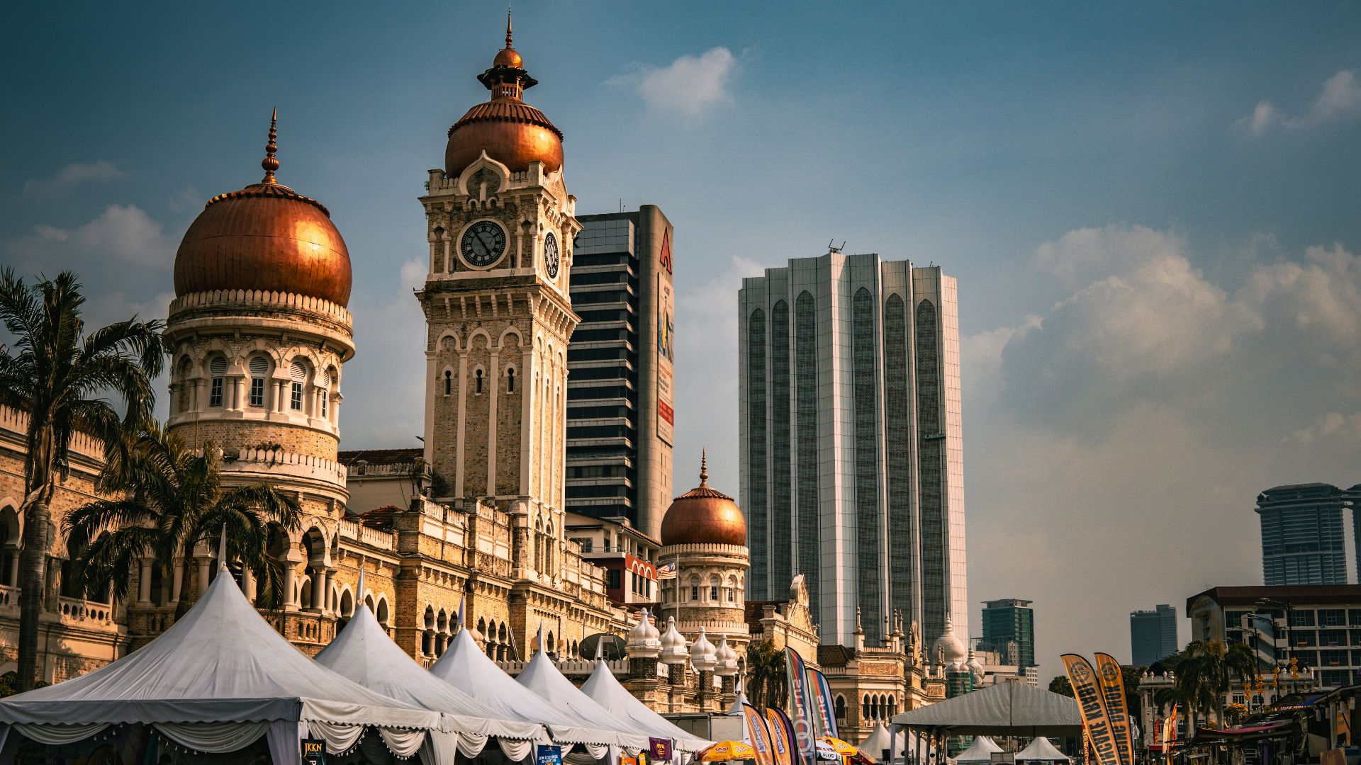 A group of people standing around tents in front of a building