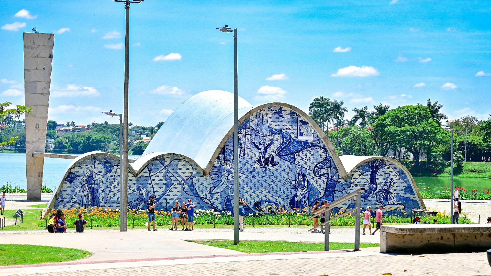 a blue and white building sitting next to a lake
