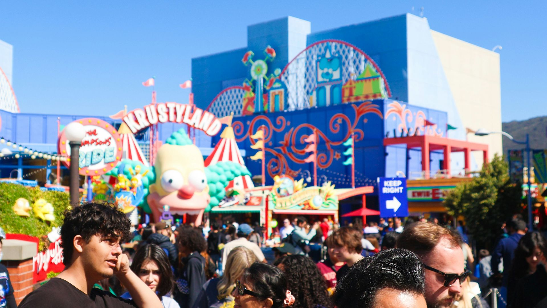 People are at a colorful amusement park.