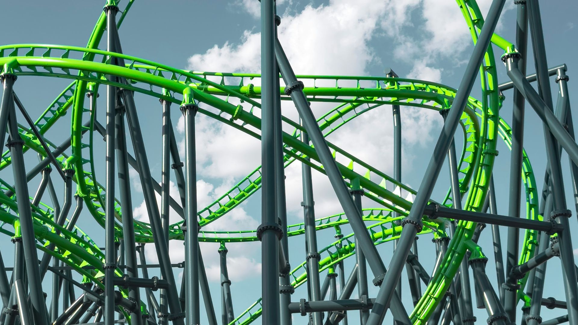 a green roller coaster going down a hill