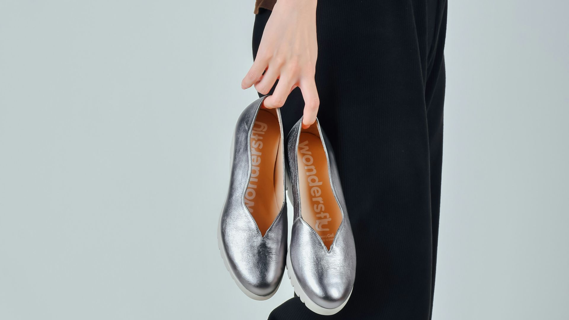 woman in black dress wearing brown leather flats