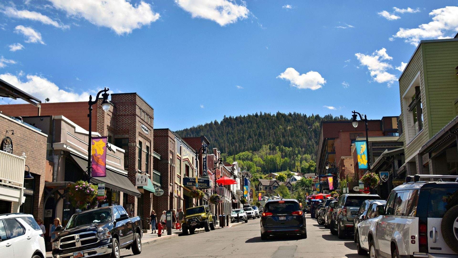 a city street with cars parked on both sides of the street