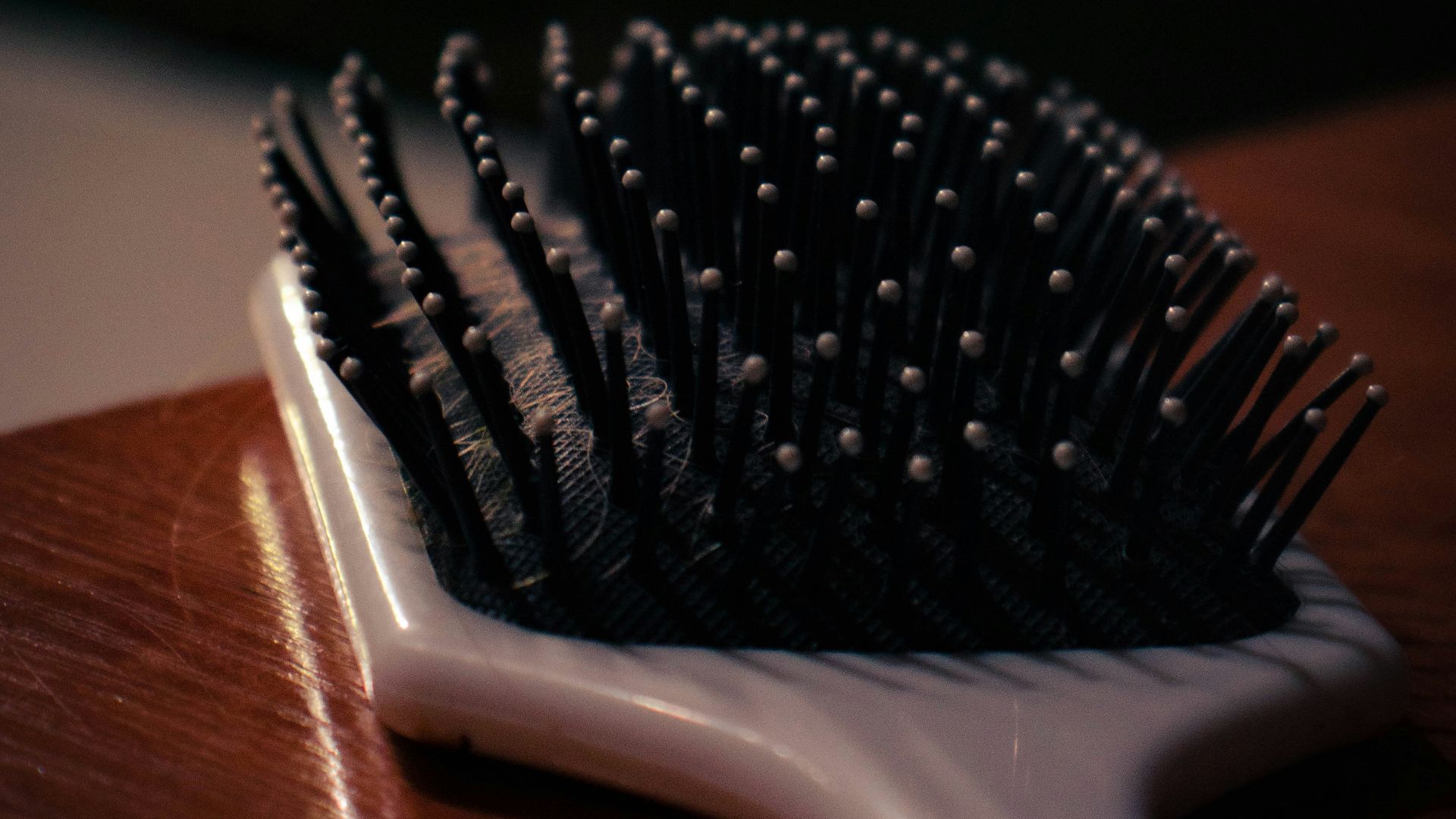 a close up of a hair brush on a table