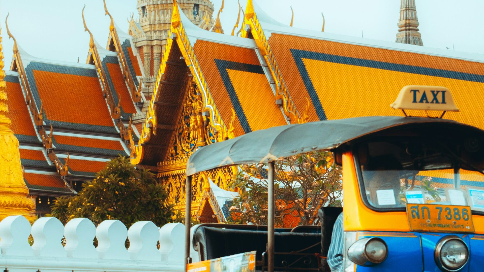 blue and yellow auto rickshaw on road during daytime