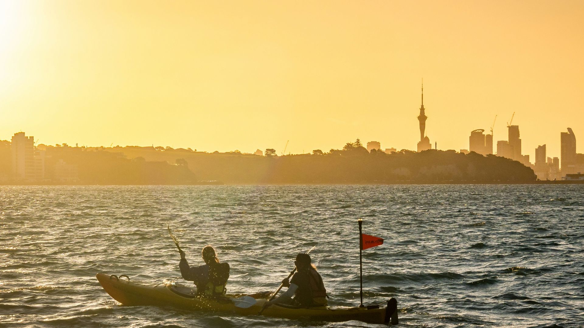 a couple of people in a small boat on a body of water