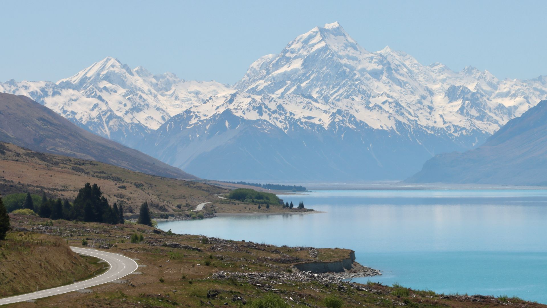 a scenic view of a mountain range with a lake in the foreground