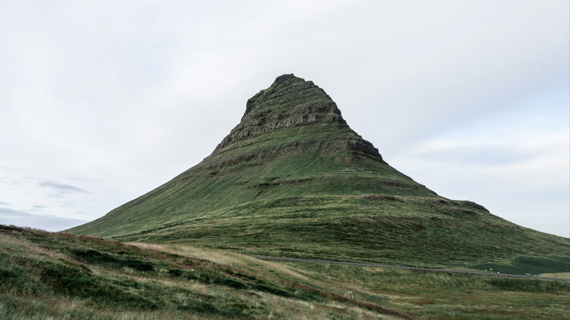 green mountain under white clouds during daytime