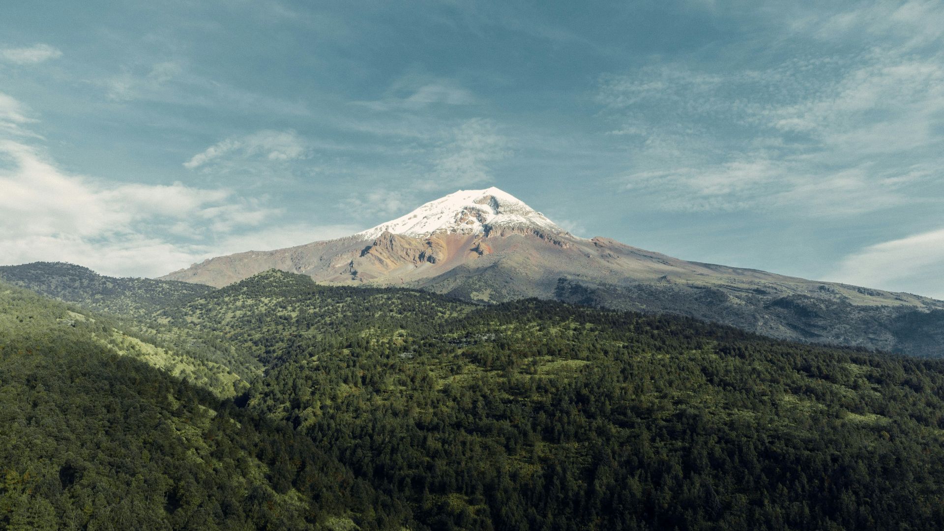a mountain with a snow capped peak in the distance