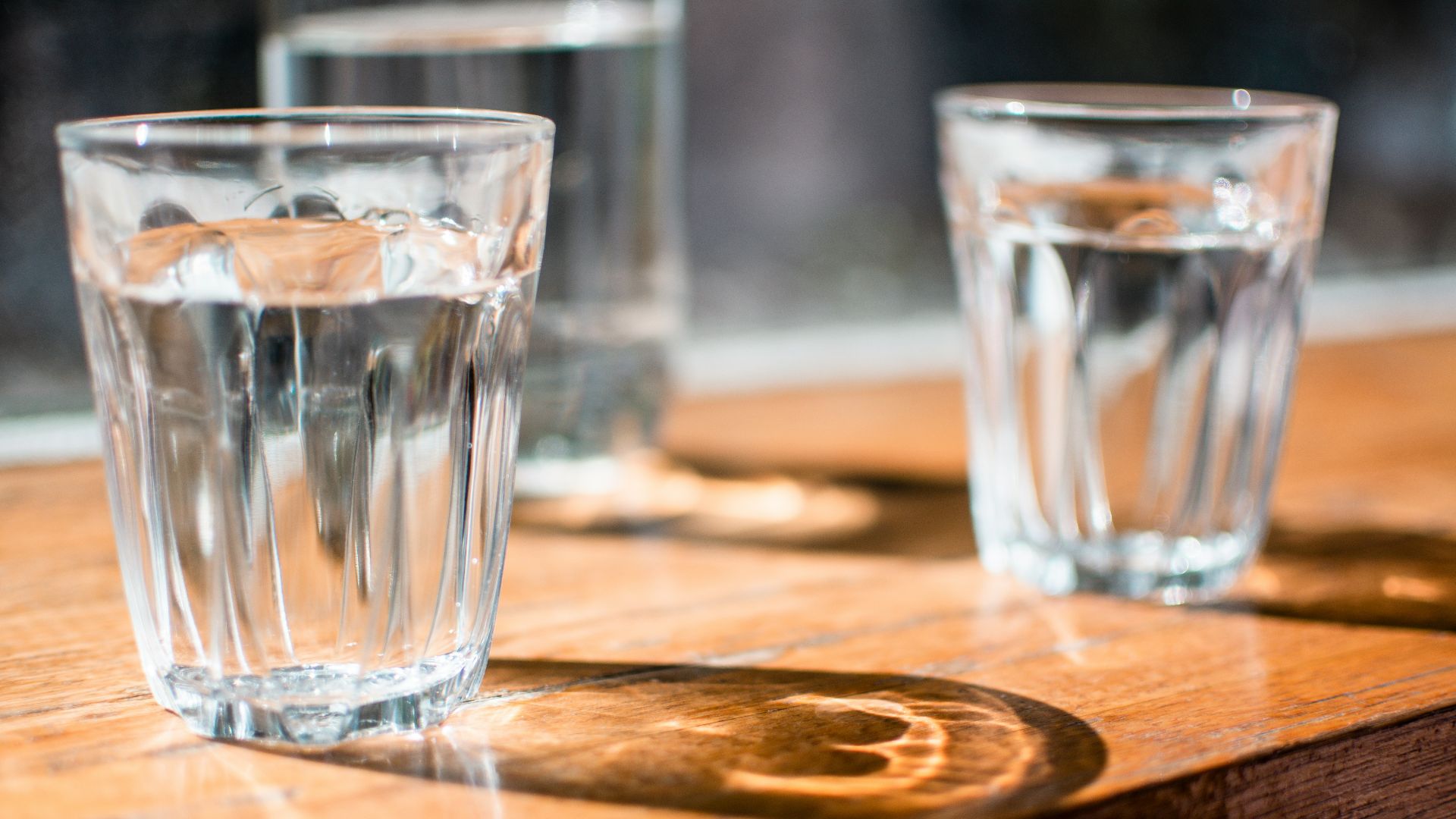 three clear drinking glass on table