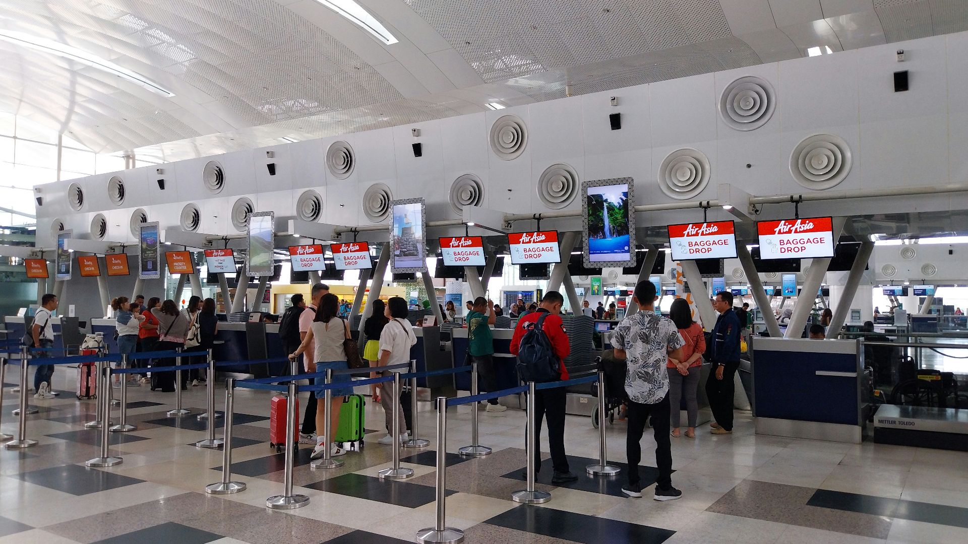 A group of people waiting in line at an airport