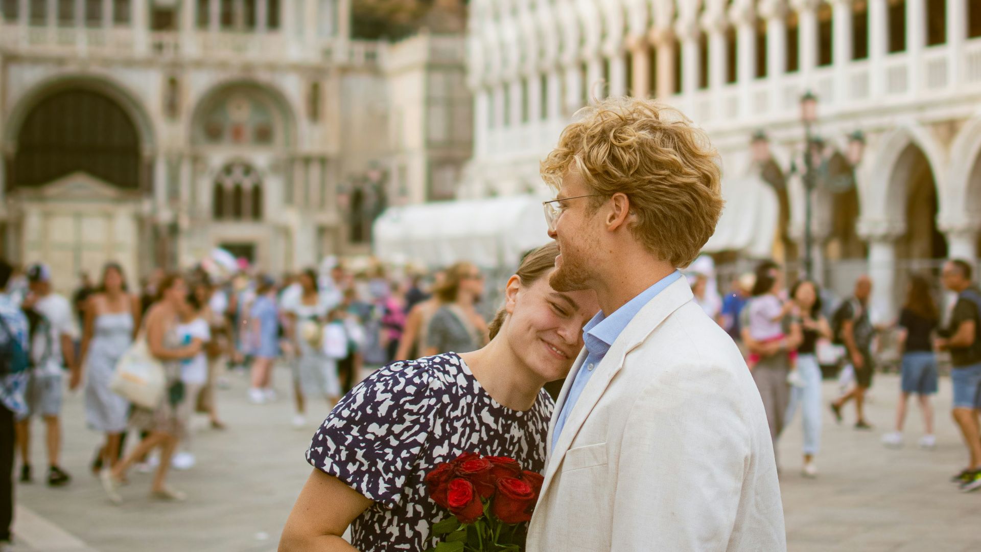 A man and a woman standing in front of a building