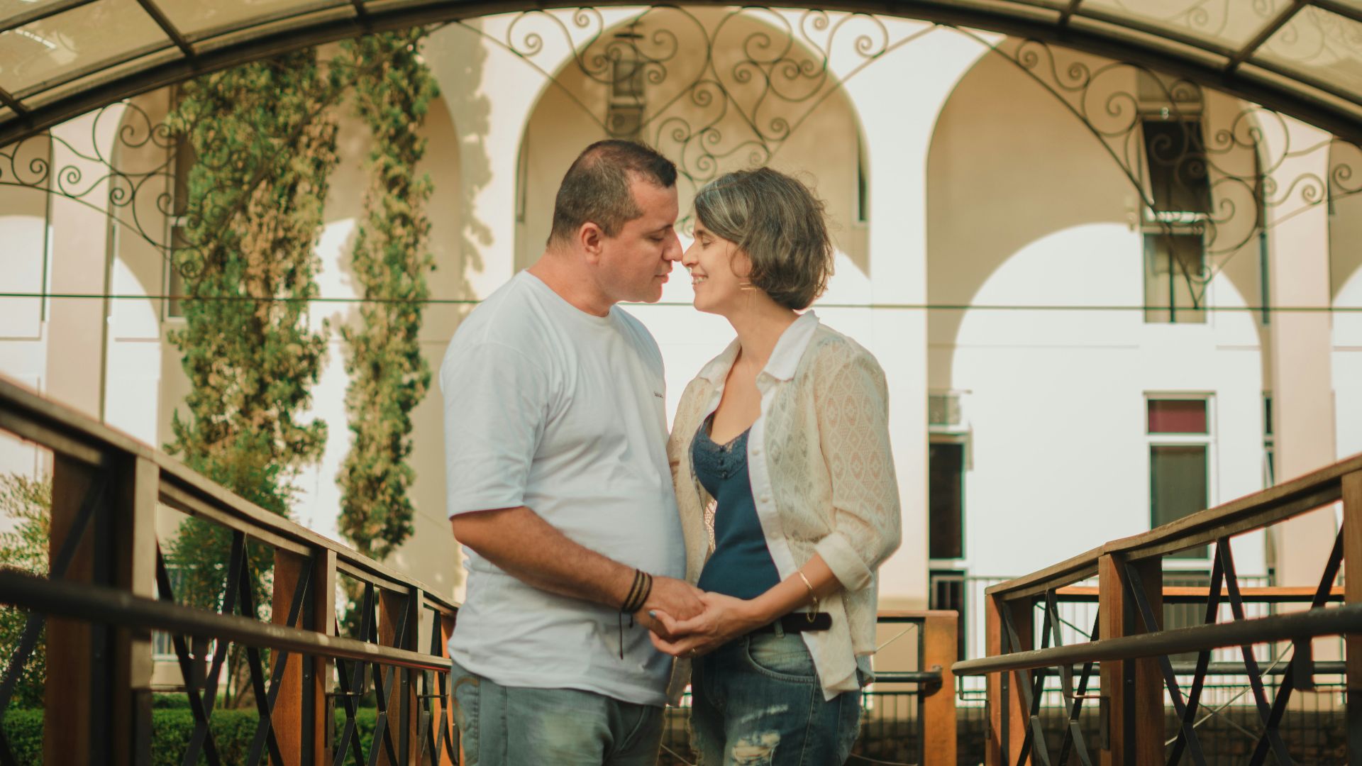 man in white dress shirt and blue denim jeans standing beside woman in blue denim jeans