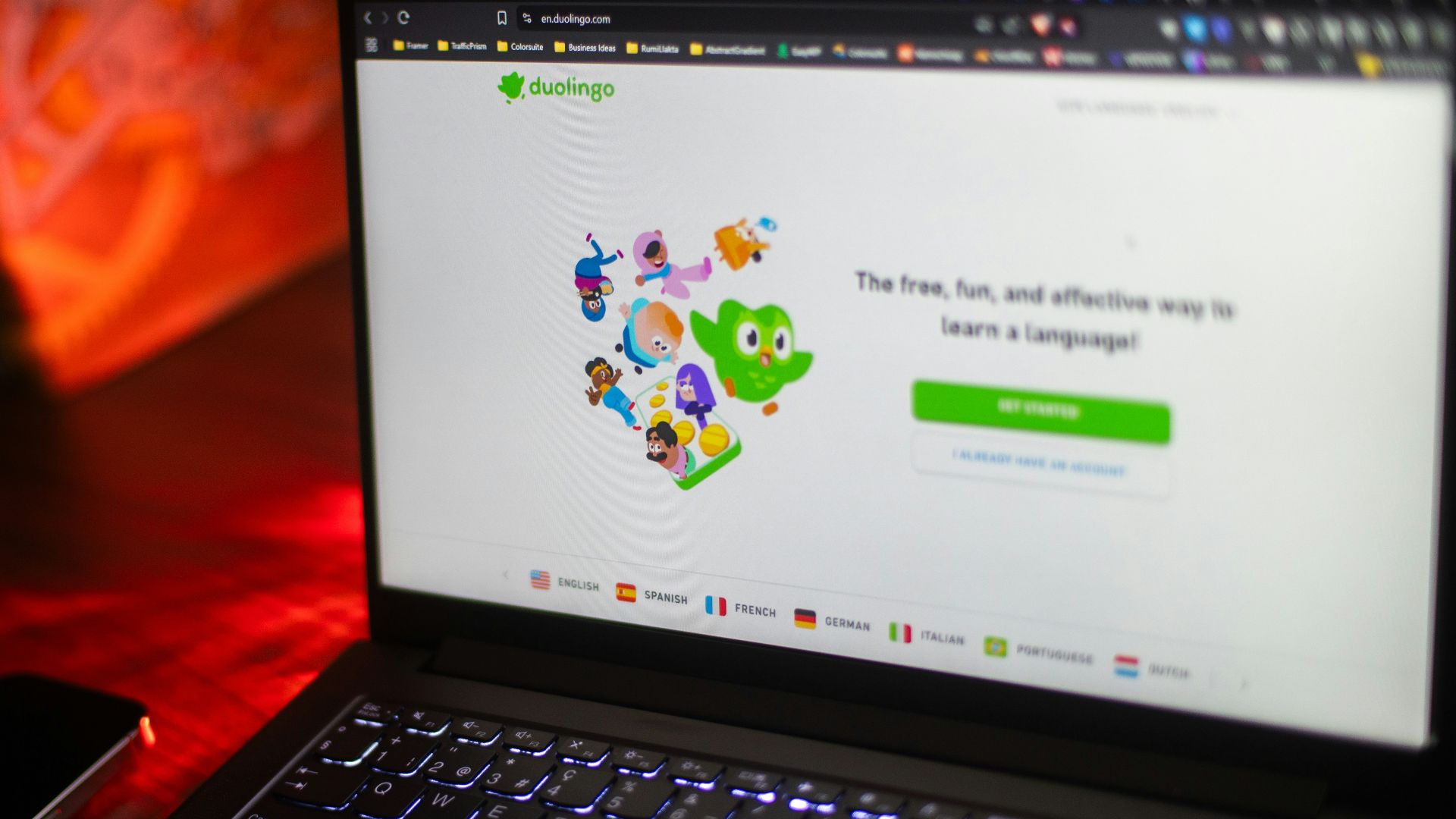 A laptop displays the duolingo homepage.