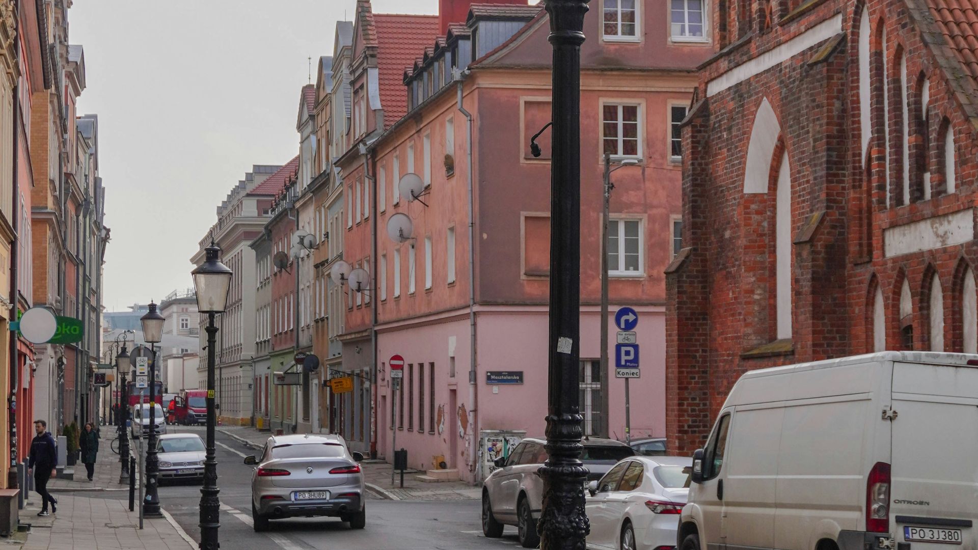 a street light sitting on the side of a road