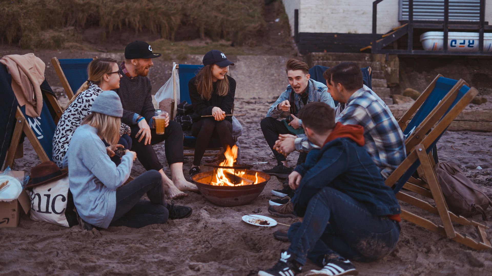 group of people sitting on front firepit