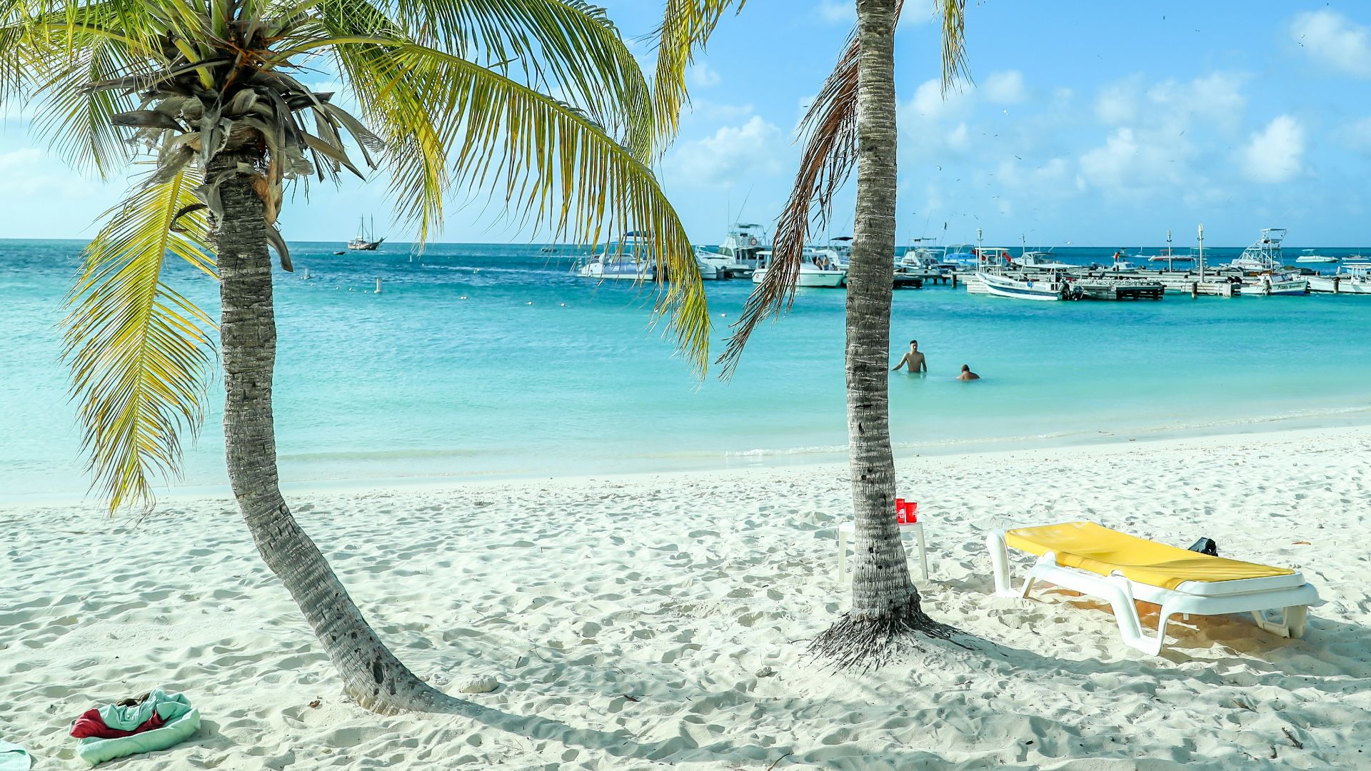 white and yellow boat on beach during daytime