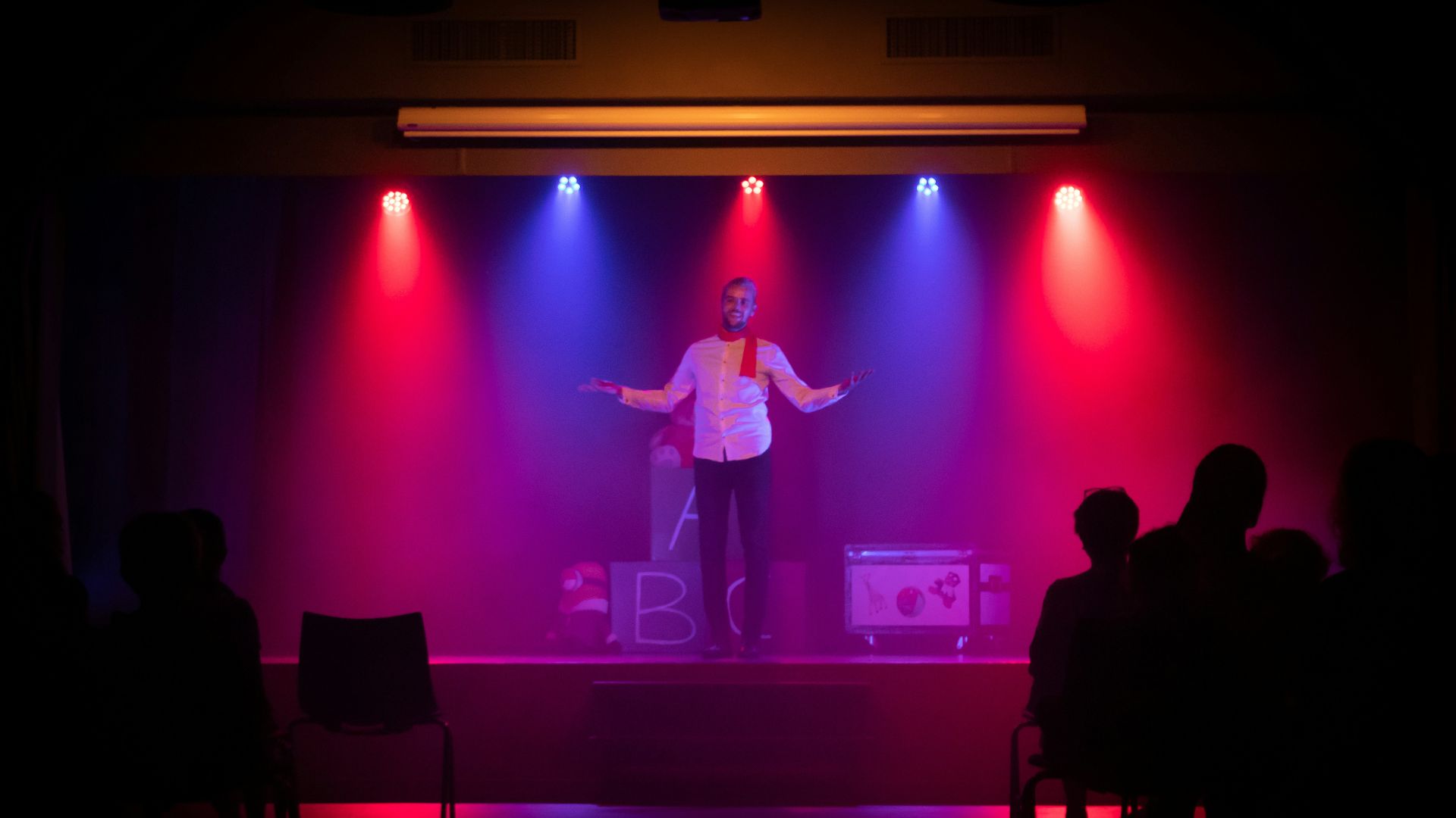 man in black shirt singing on stage