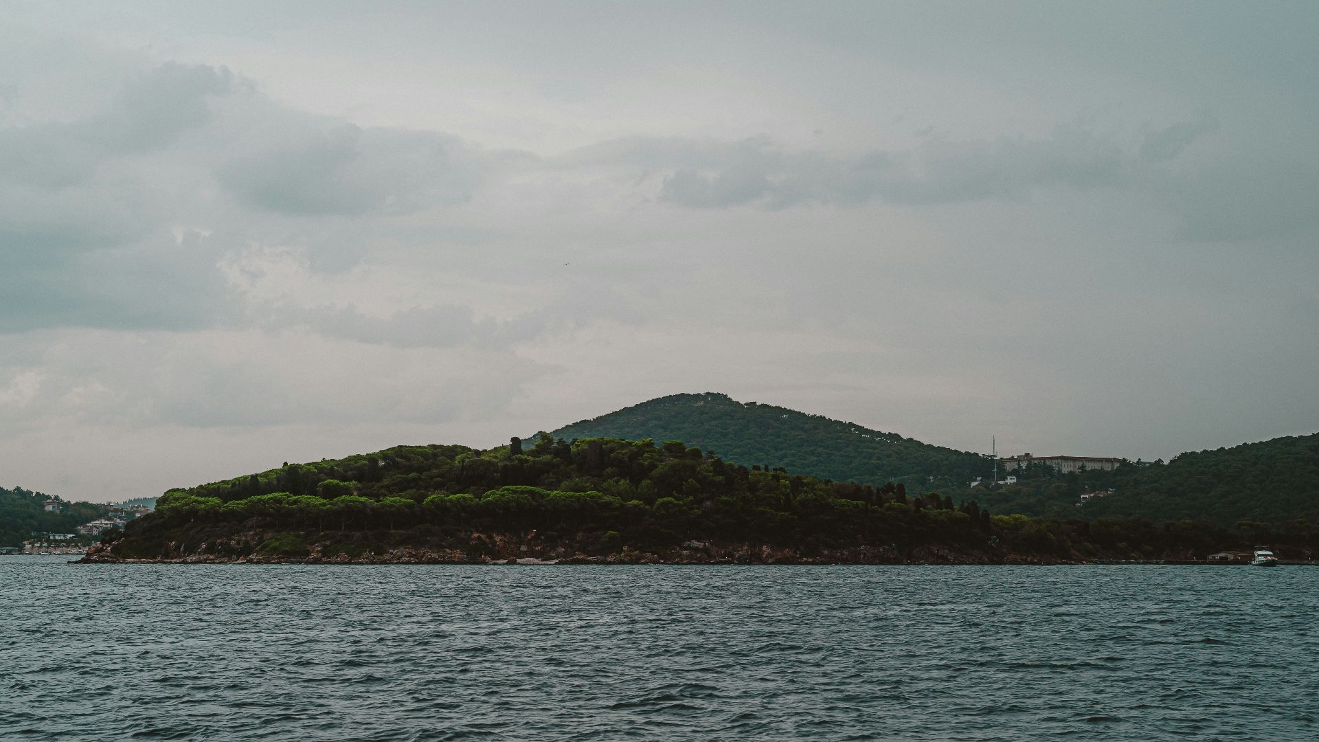 Islands and sea under a cloudy sky.
