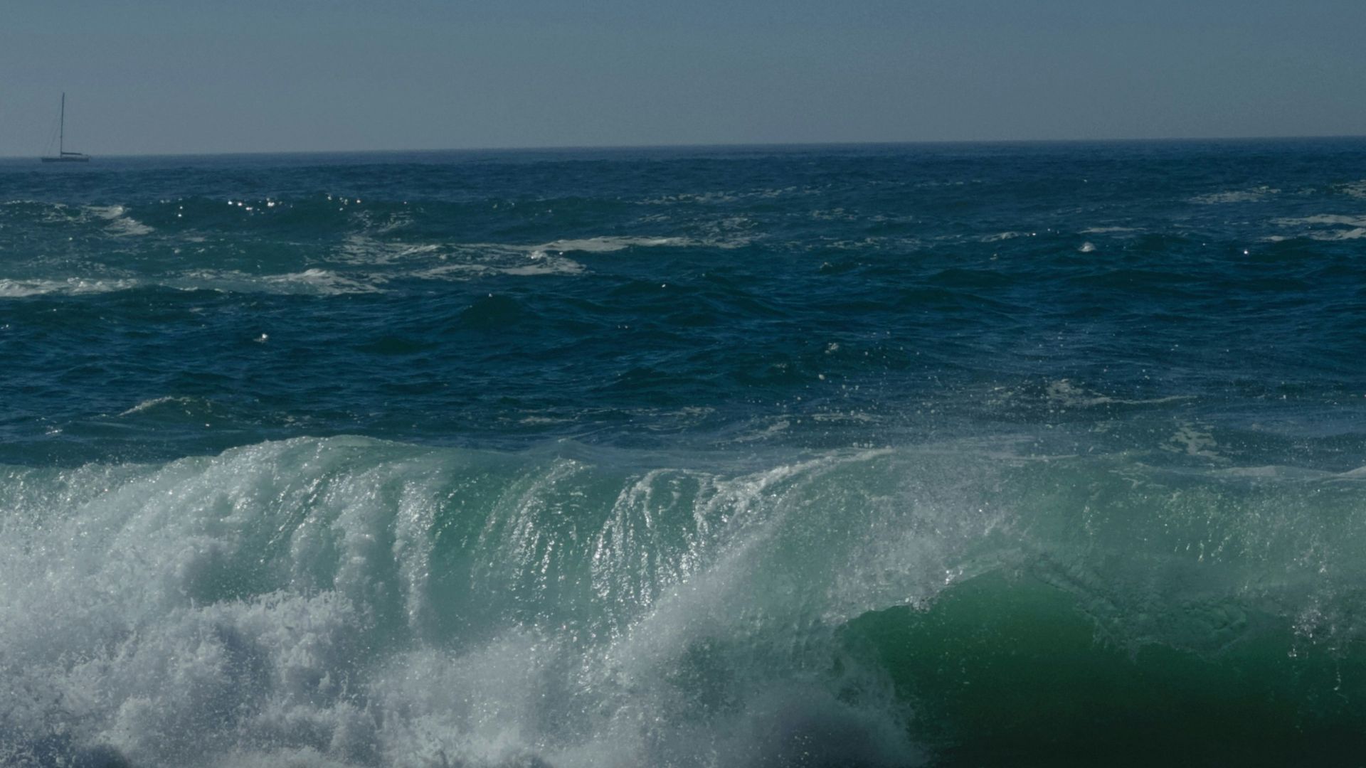 a person riding a surfboard on top of a wave