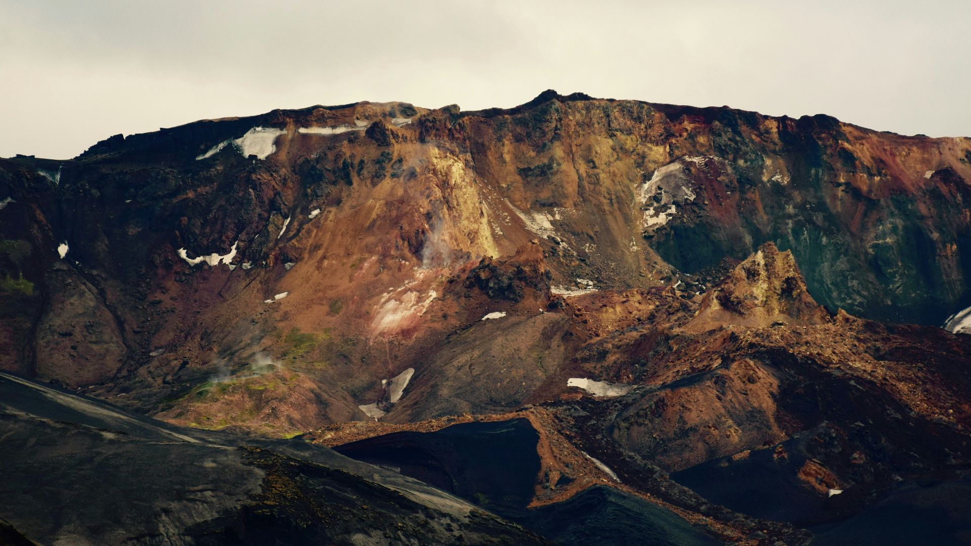 photo of mountain under white sky
