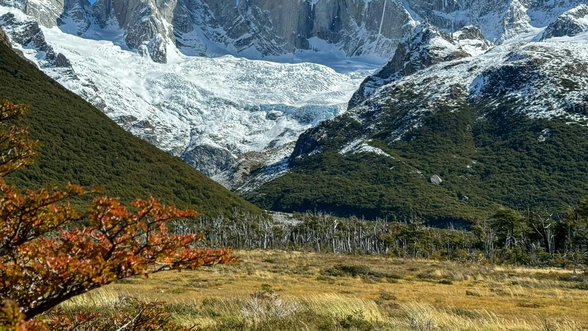 a mountain range with snow covered mountains in the background