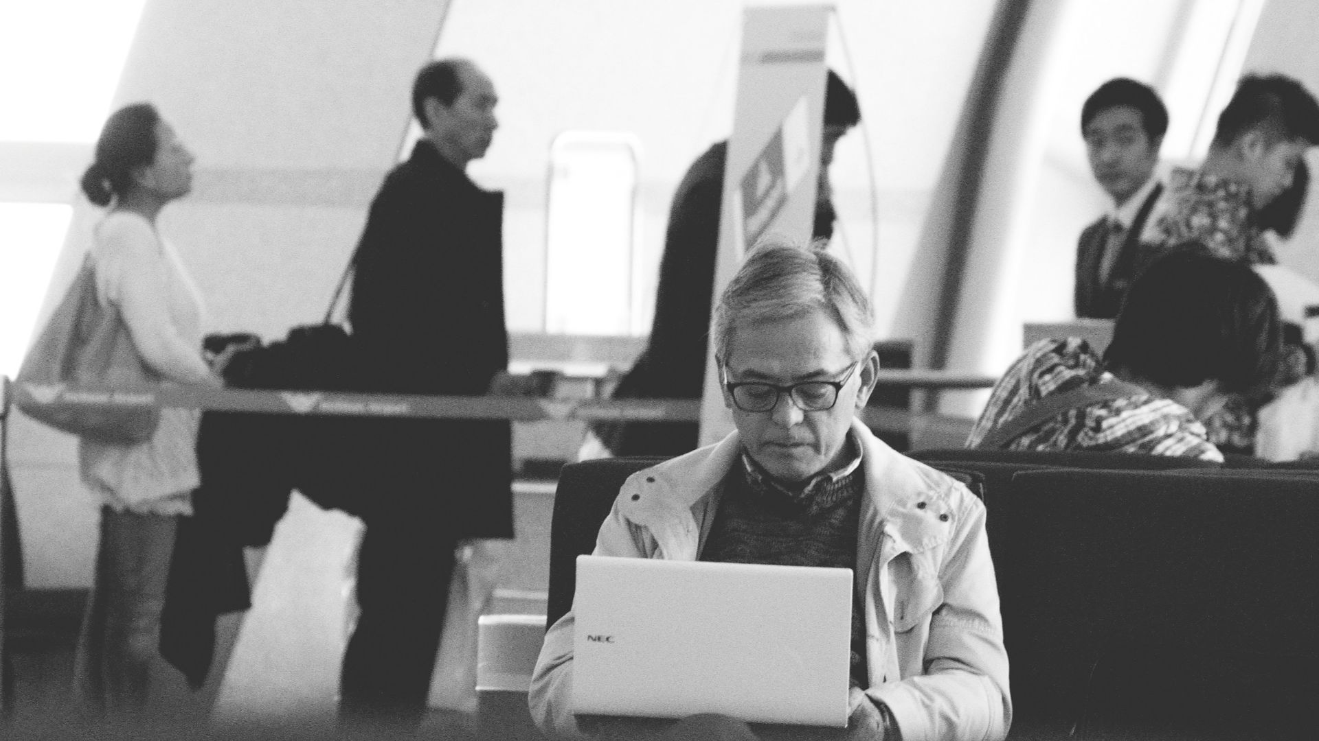 a man sitting at a table using a laptop computer