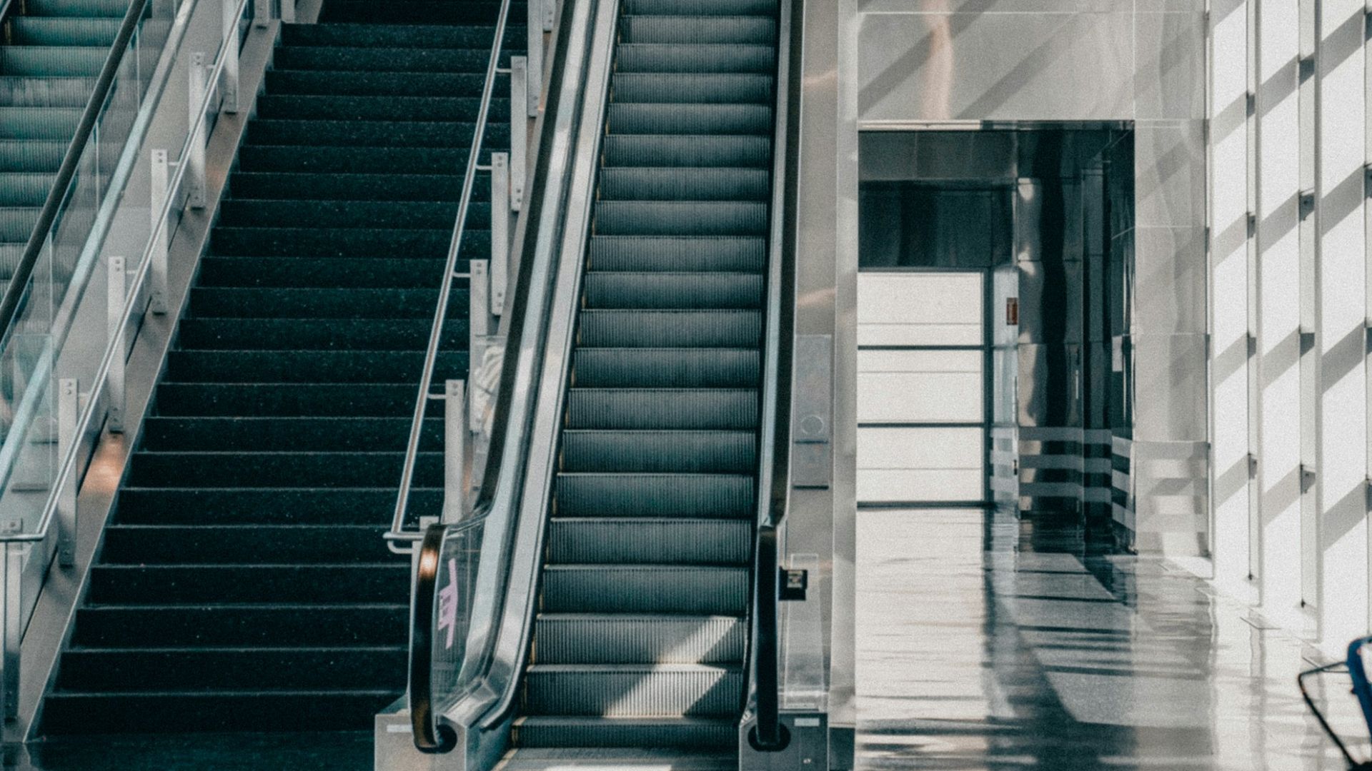 an escalator and stairs in a building