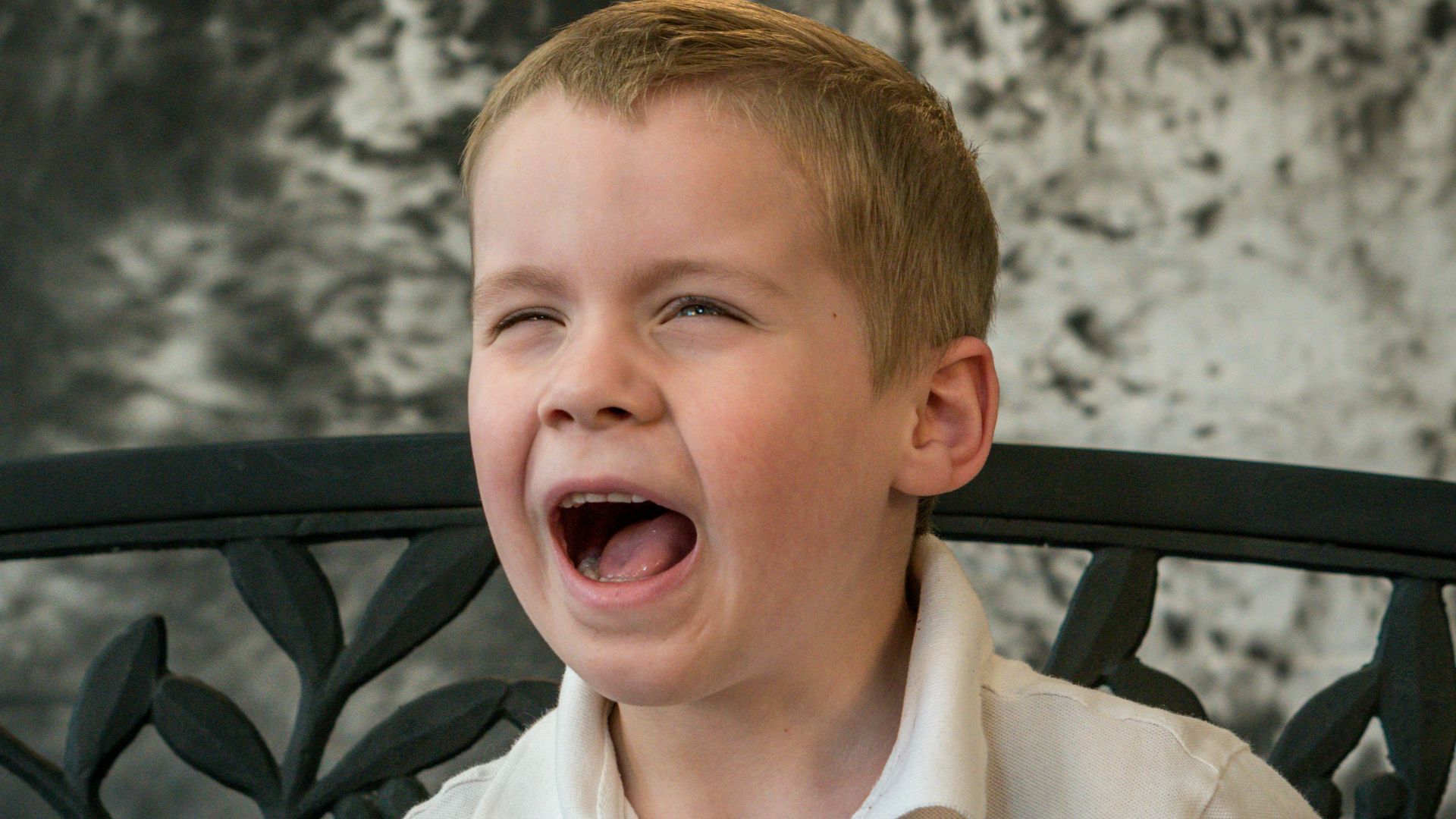 shallow focus photo of boy in white button-up shirt