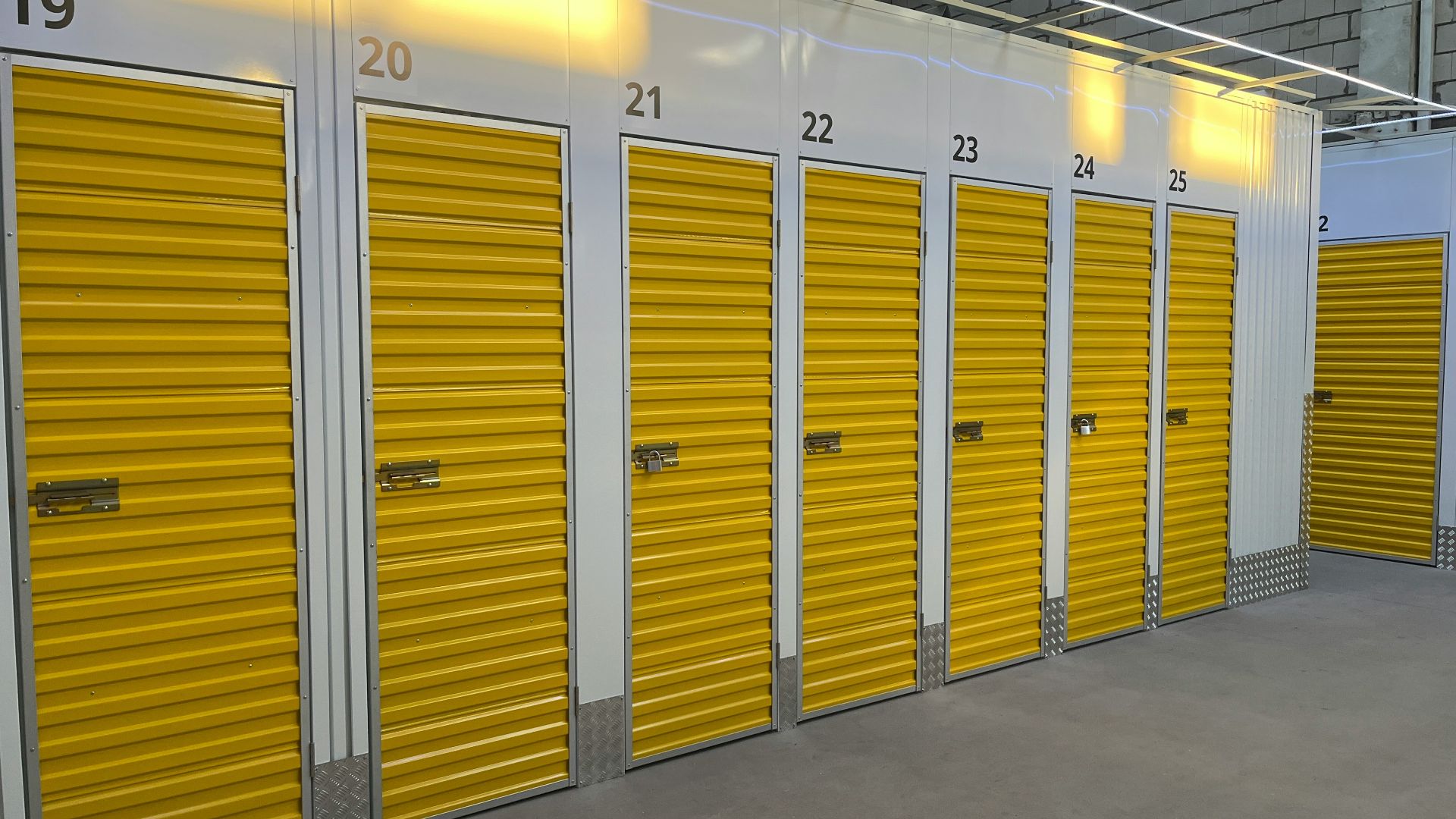 a row of storage units with yellow doors