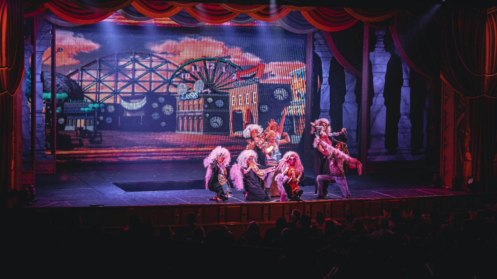 crowd of people watching a stage performance in the theater
