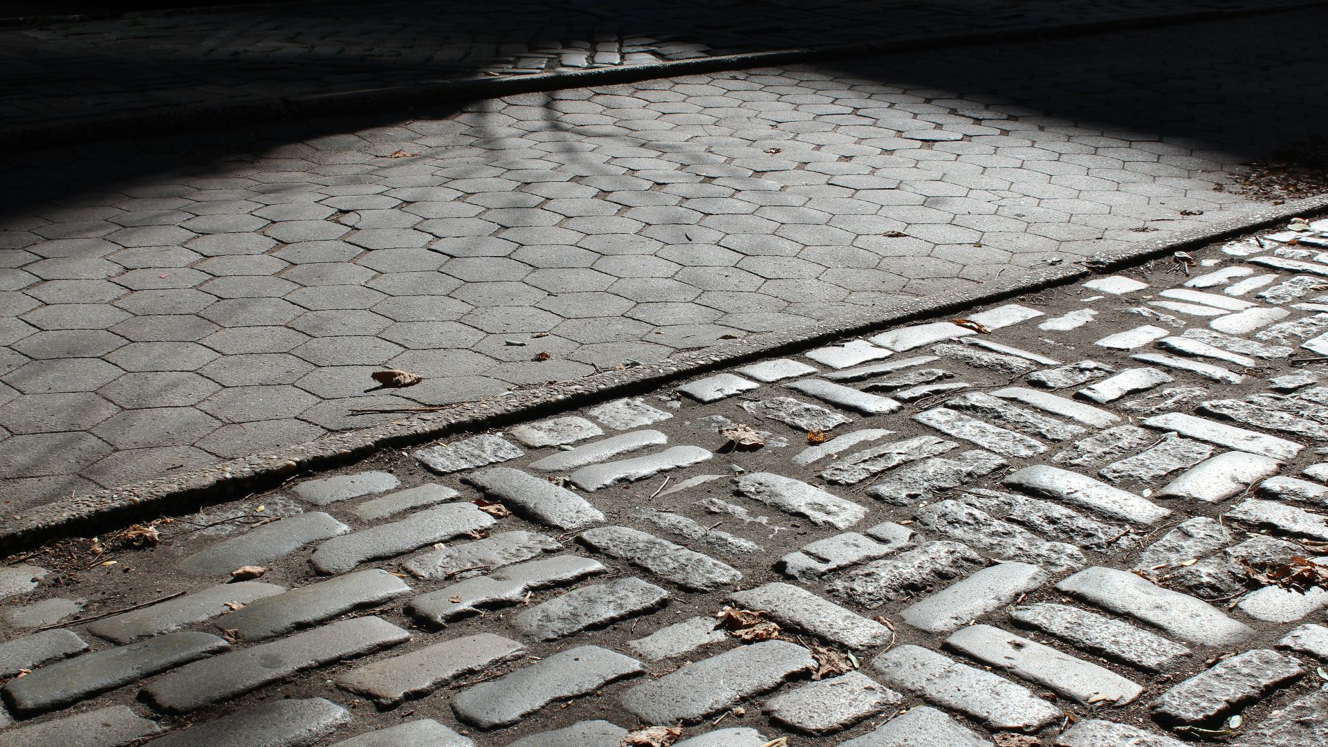 a brick sidewalk with a stop sign on it