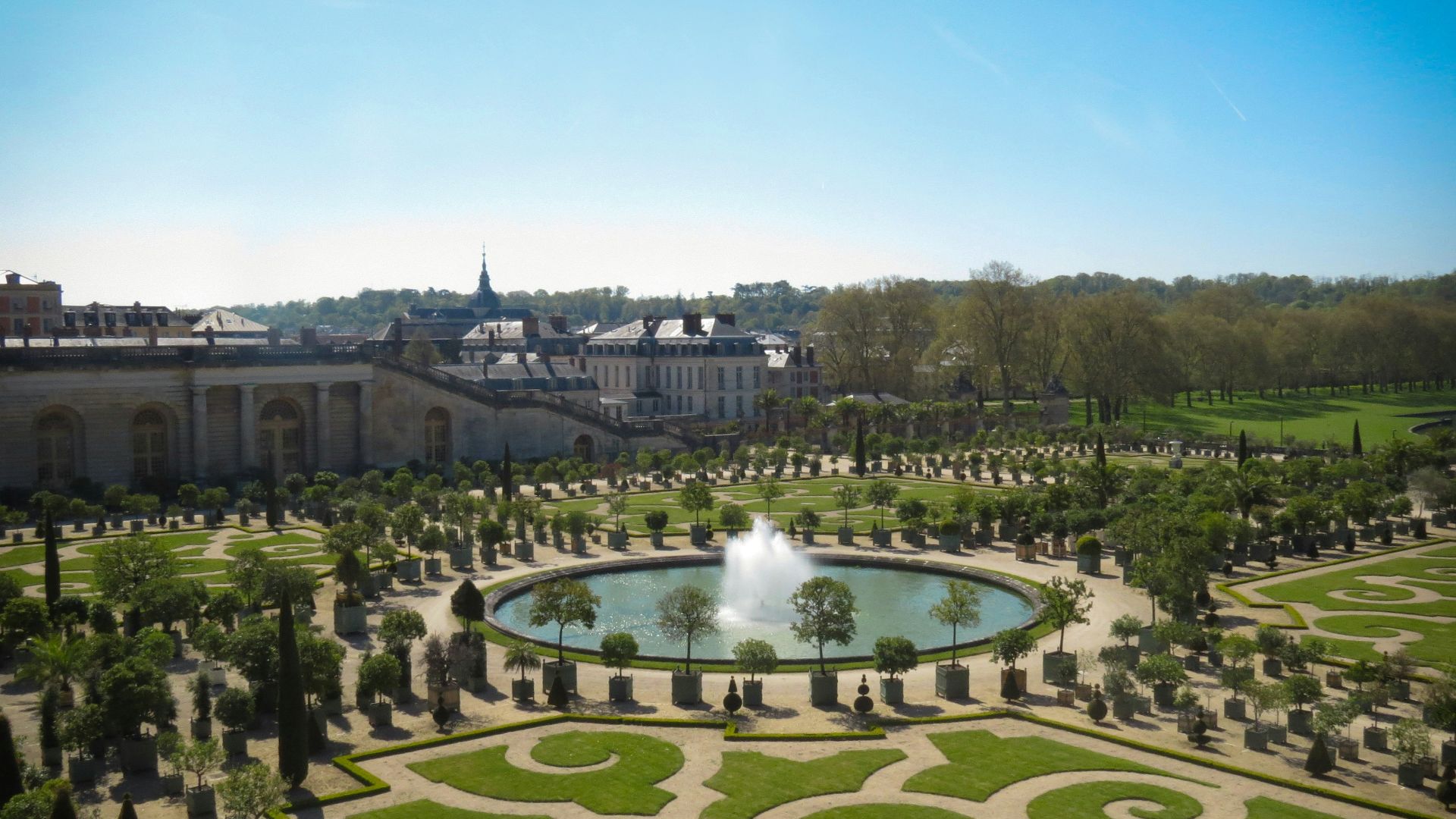 green grass field with fountain during daytime