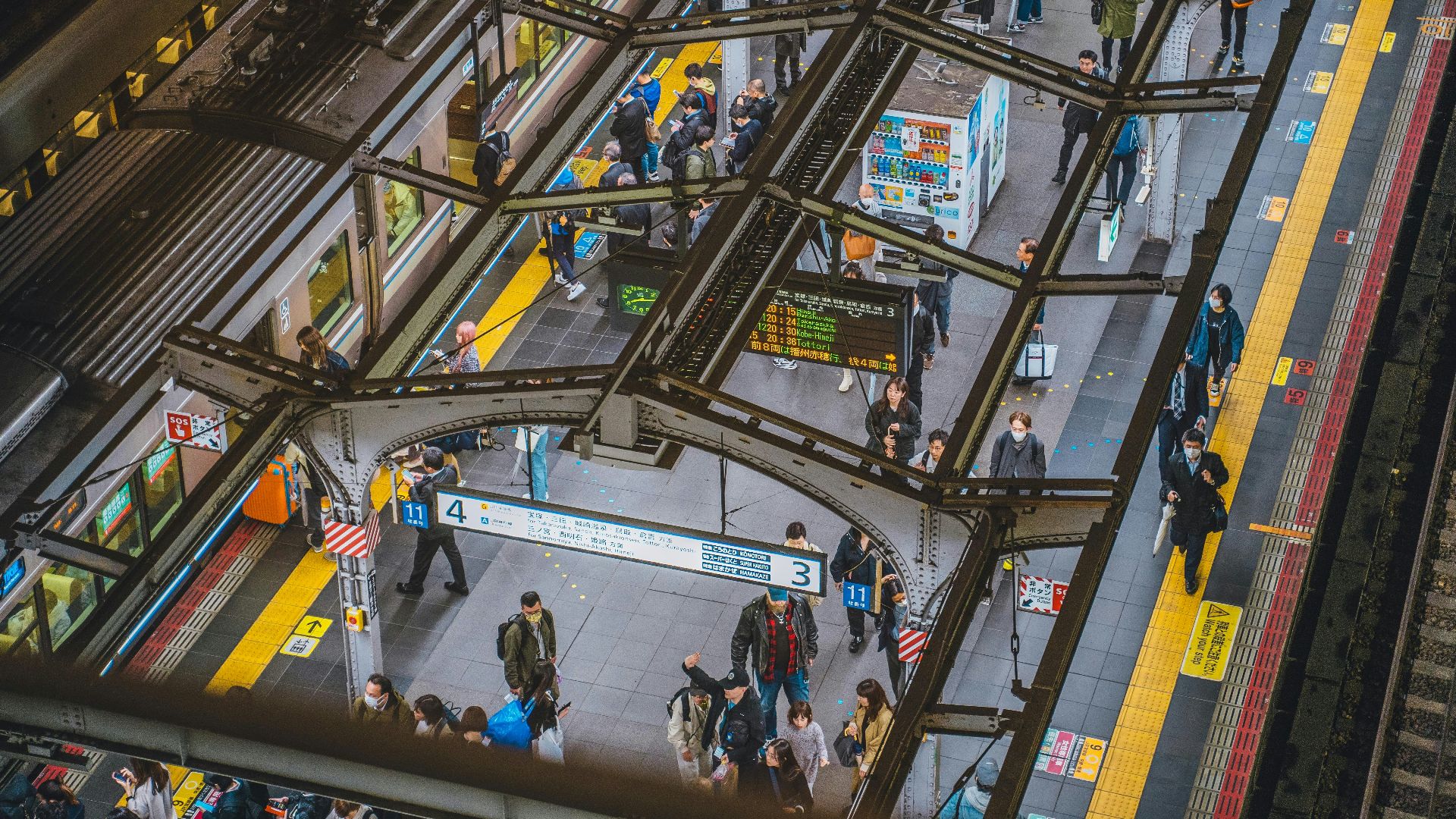 a group of people standing around a train station