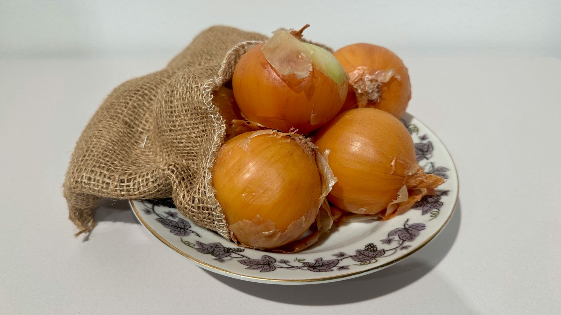 A bag of onions sitting on top of a plate