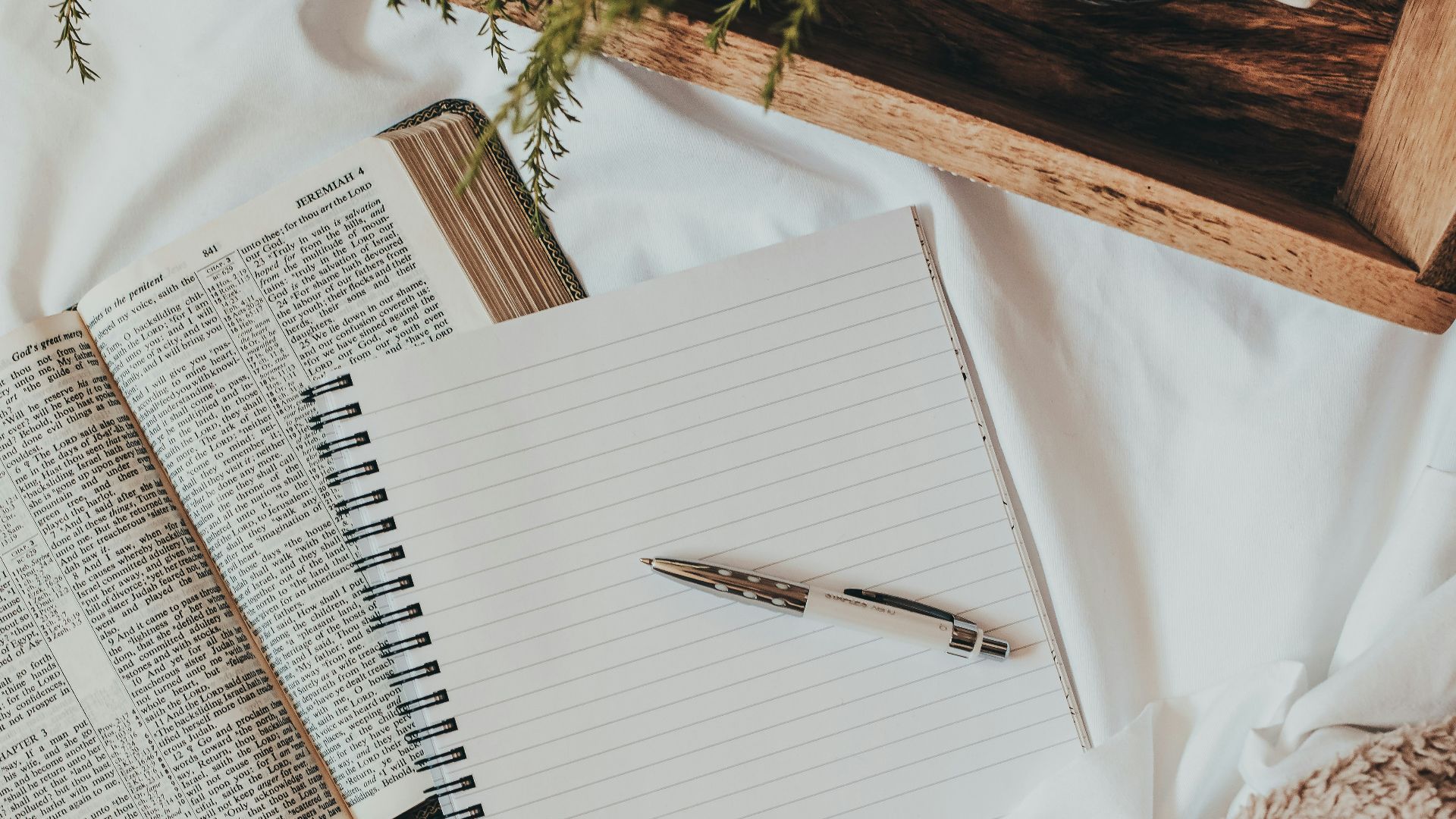 white notebook on white textile