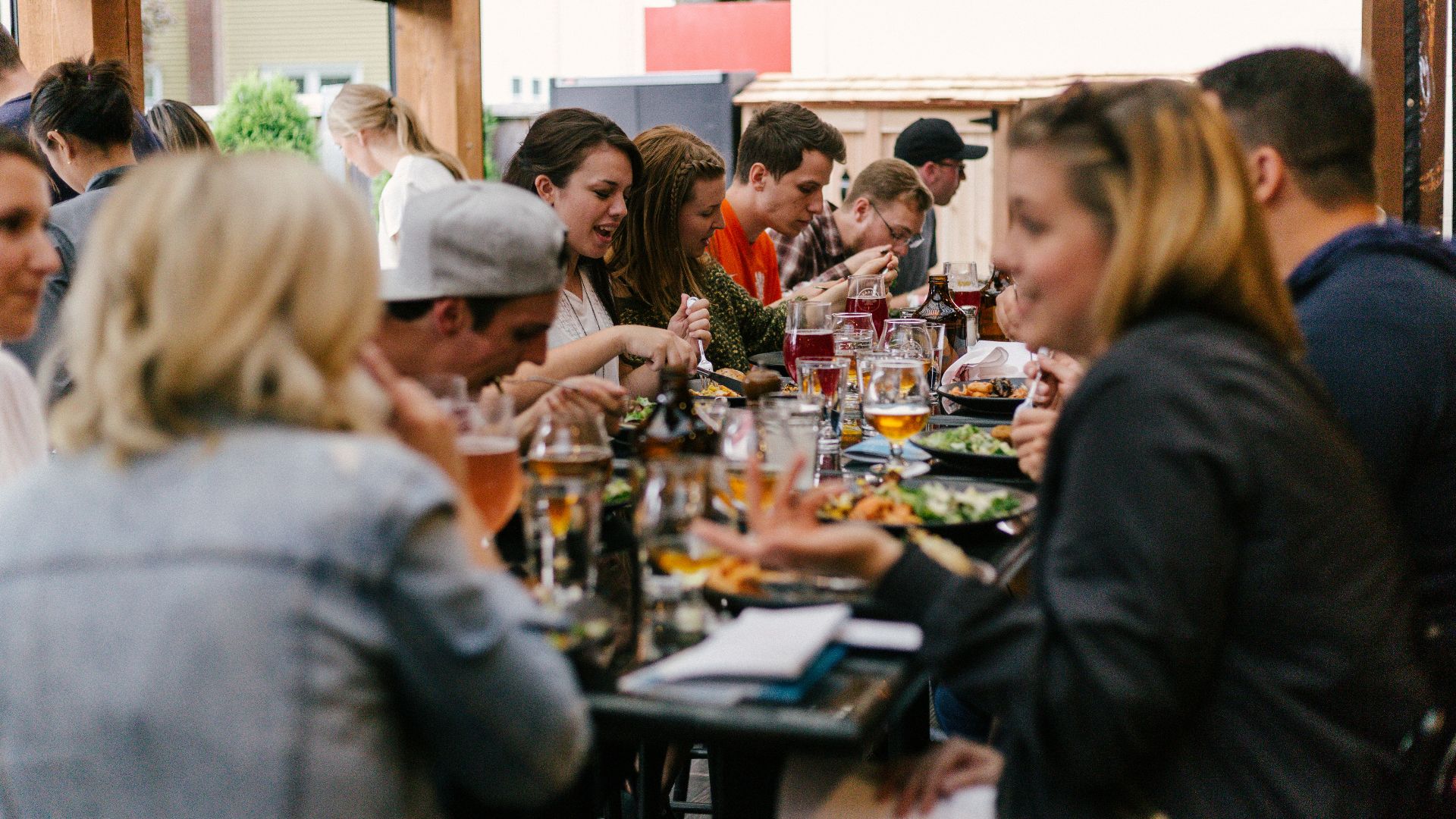 people sitting in front of table talking and eating
