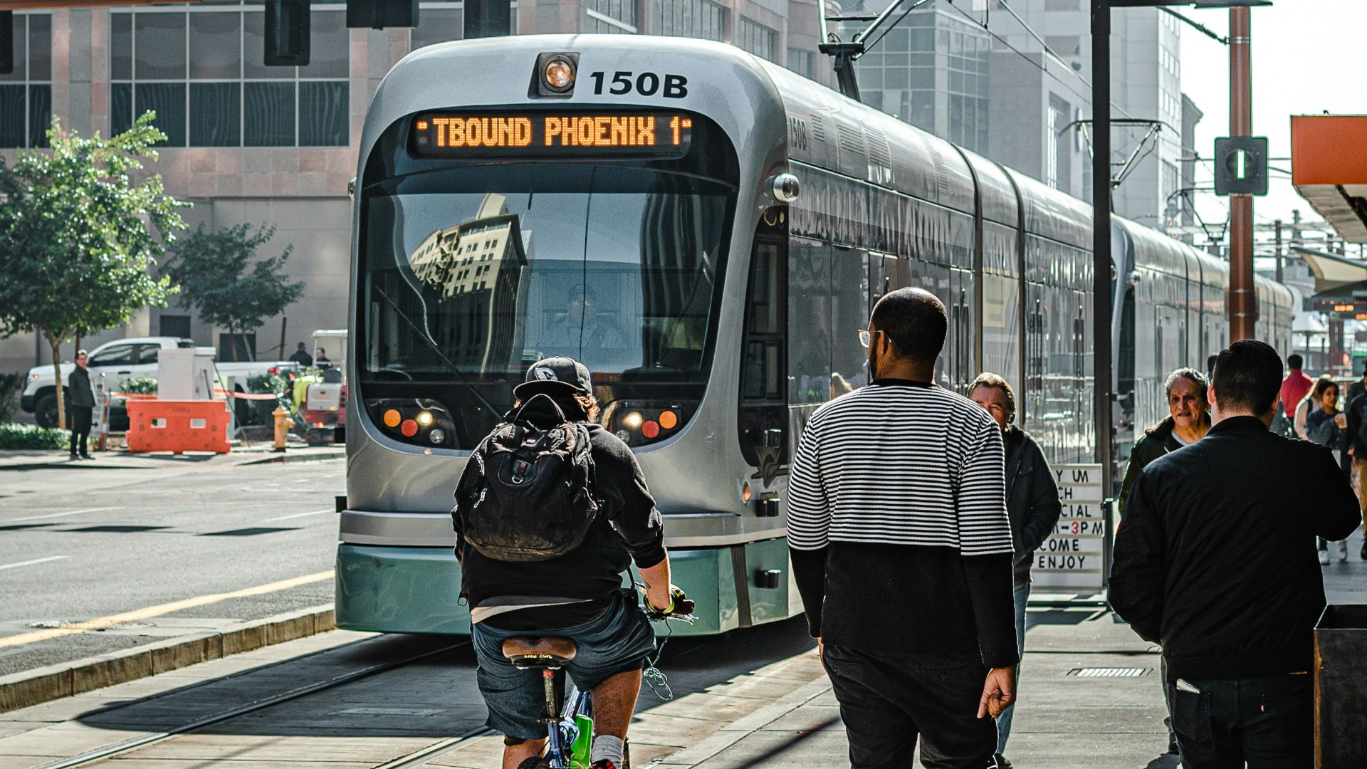 people walking on pedestrian lane near white and red train during daytime