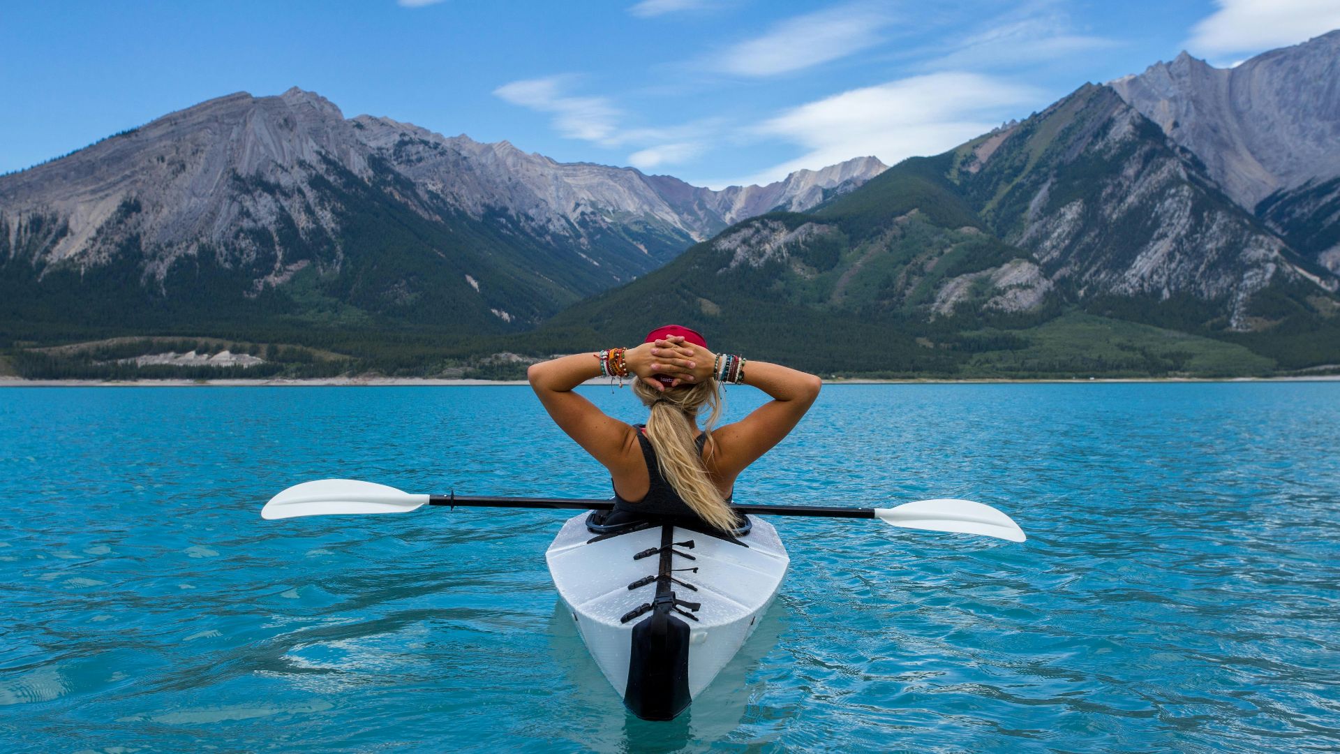 woman riding kayak at the middle of the sea