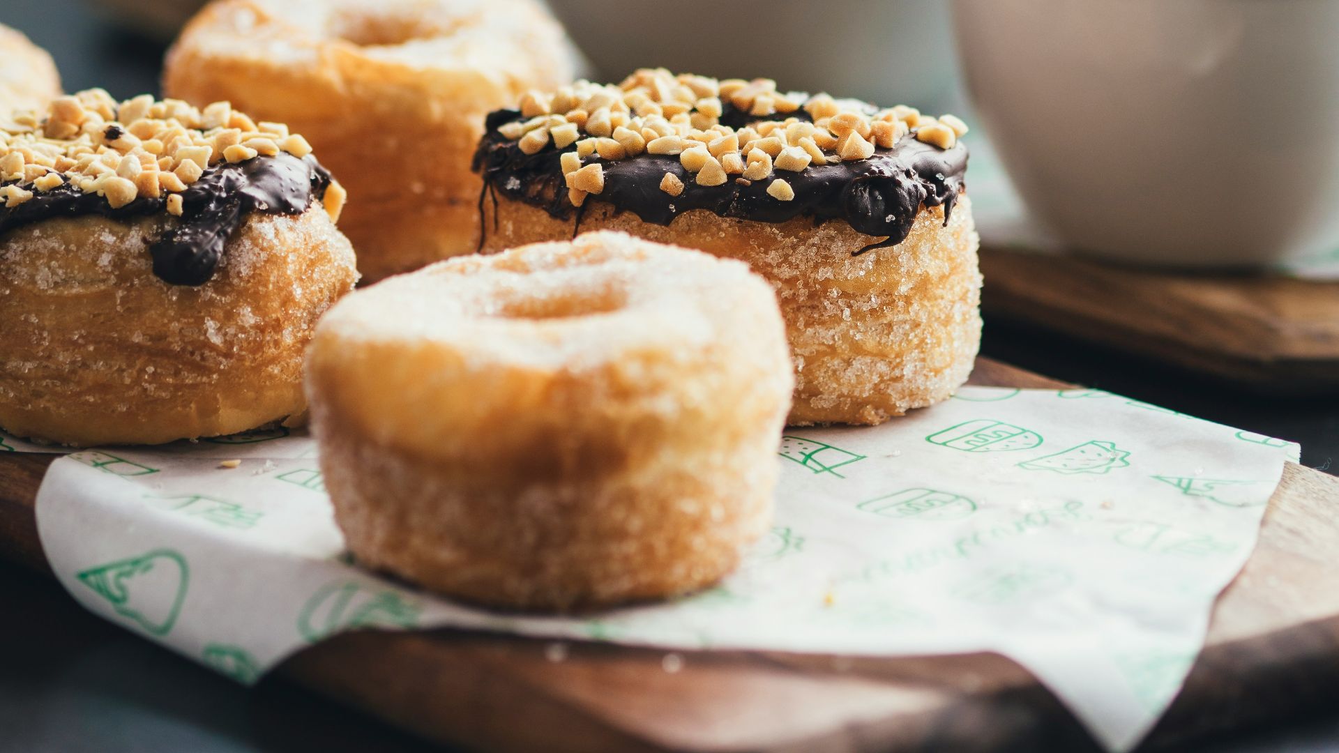 doughnuts topped with chocolate and peanuts selective focus photography