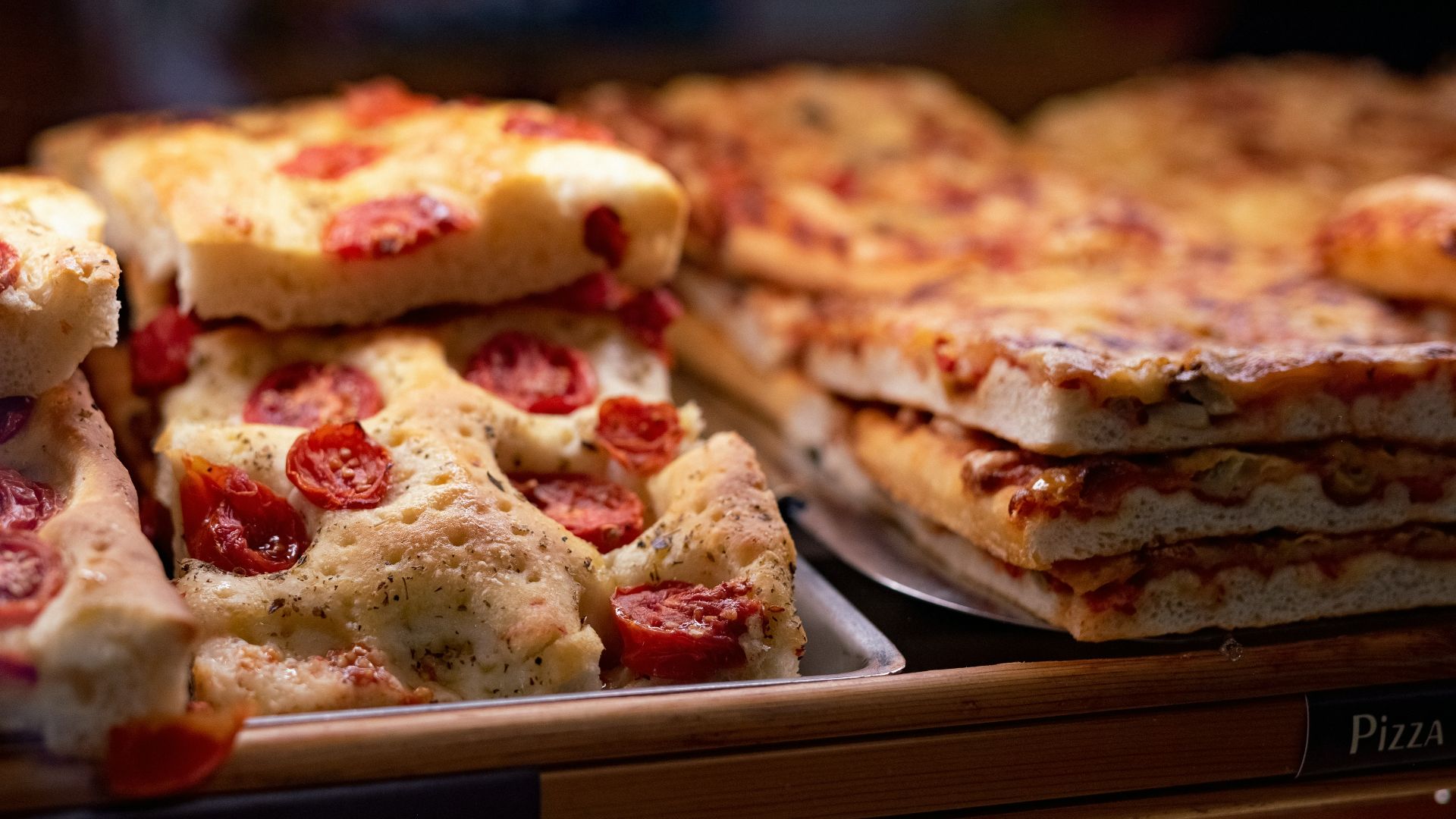 a close up of many different types of pizza