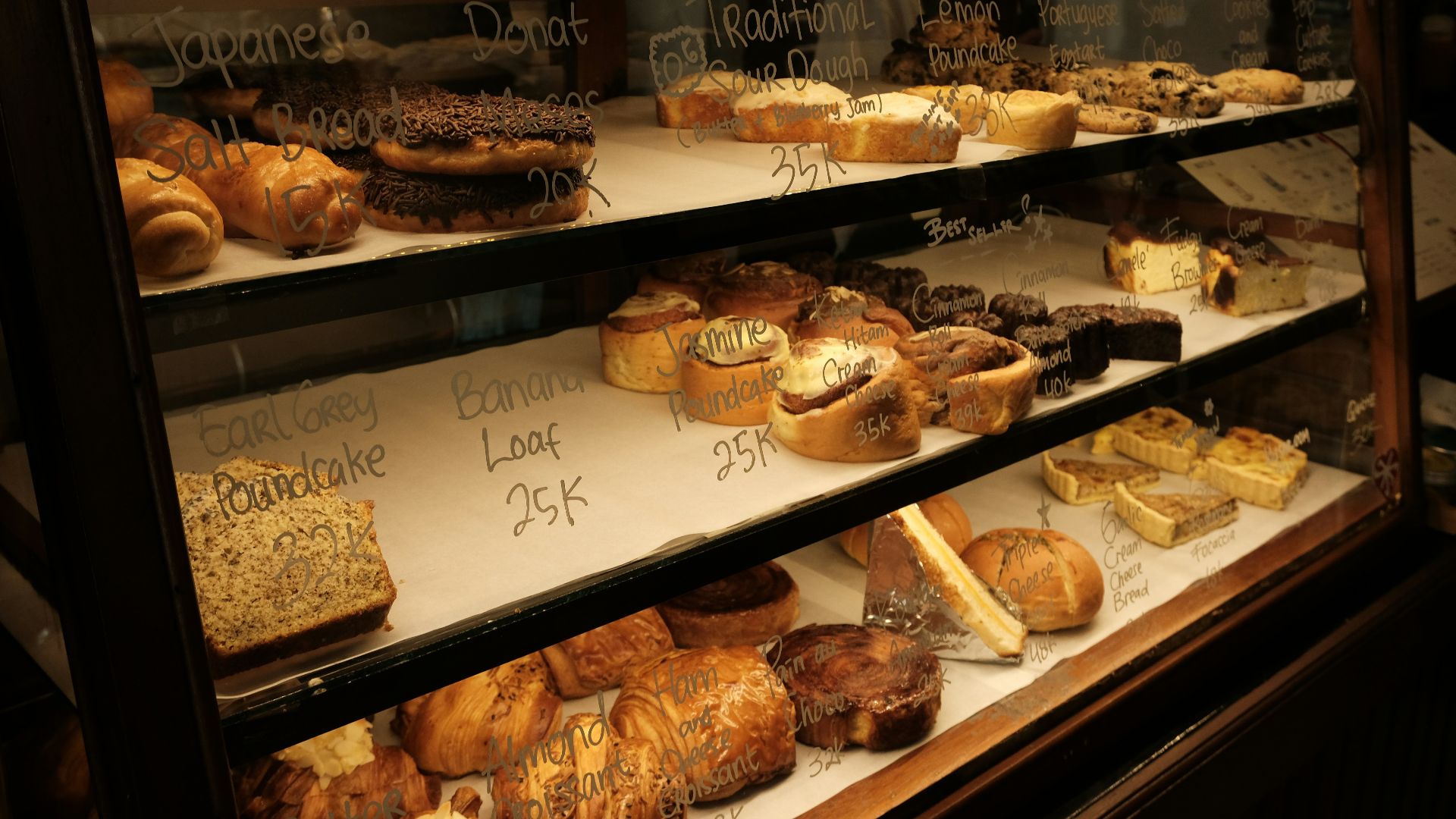Display case filled with various baked goods and pastries.