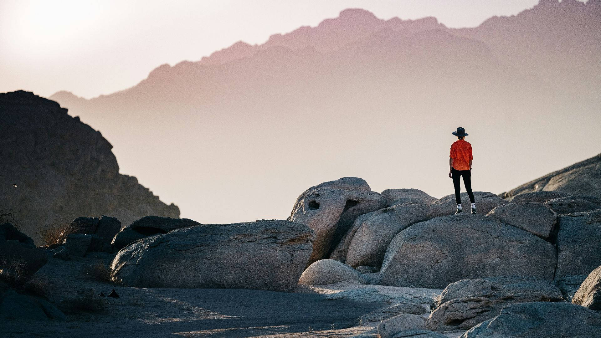a person standing on top of a large rock