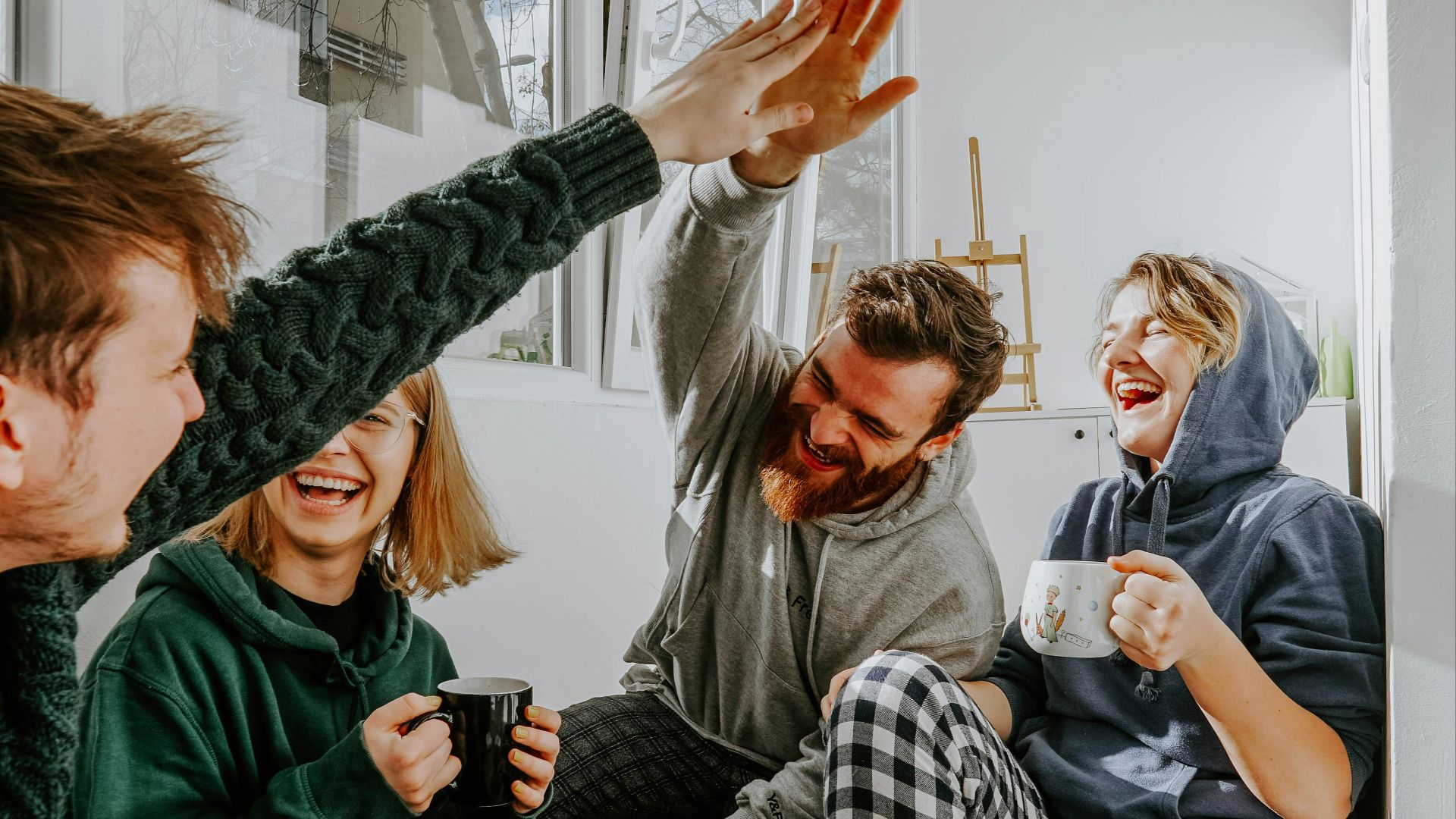 woman in black and white checkered long sleeve shirt sitting beside man in green crew neck