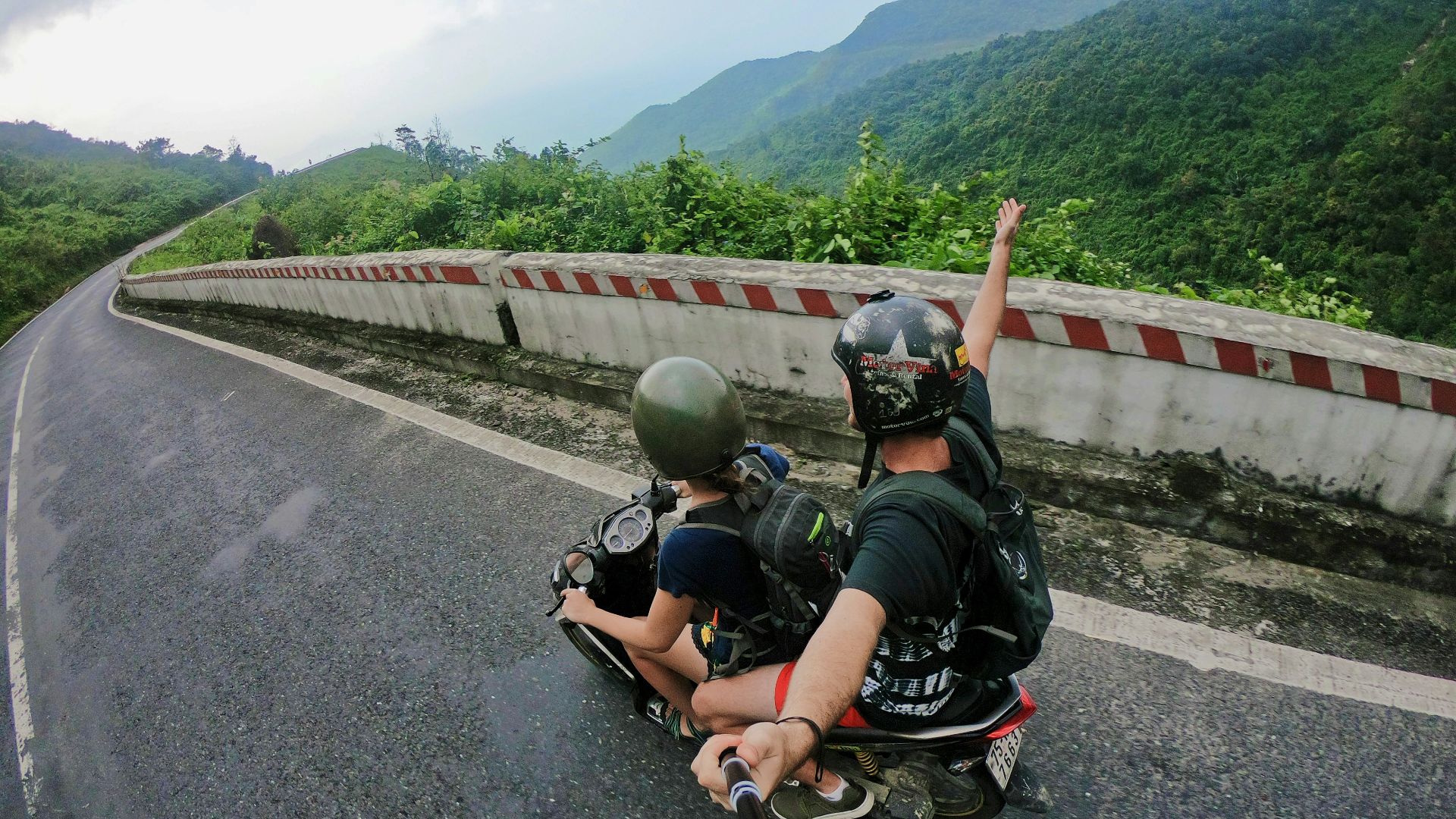 fish eye photography on woman riding motor scooter with man on bridge