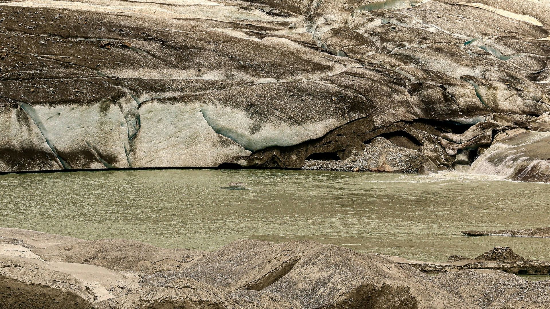 Melting glacier with a pool of water