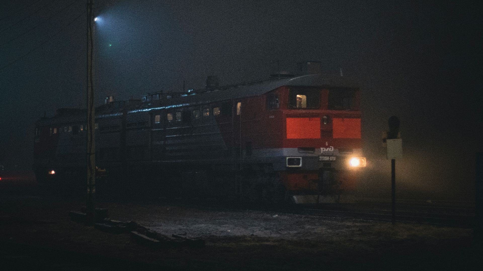 a train traveling down train tracks at night
