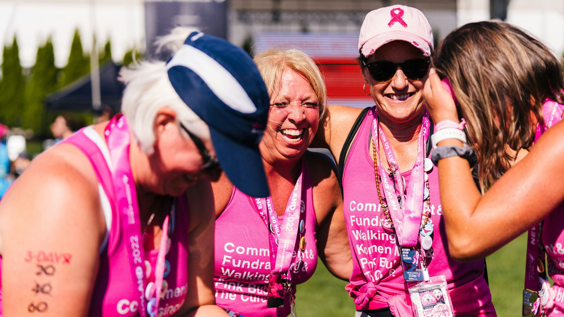 a group of women in pink shirts and hats