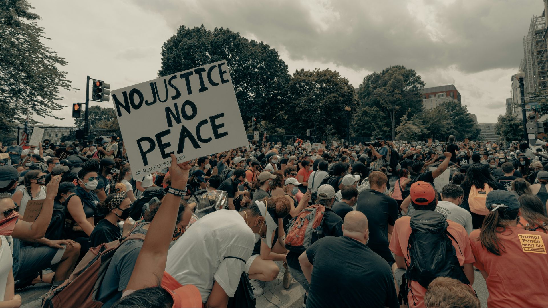 a large crowd of people holding up signs