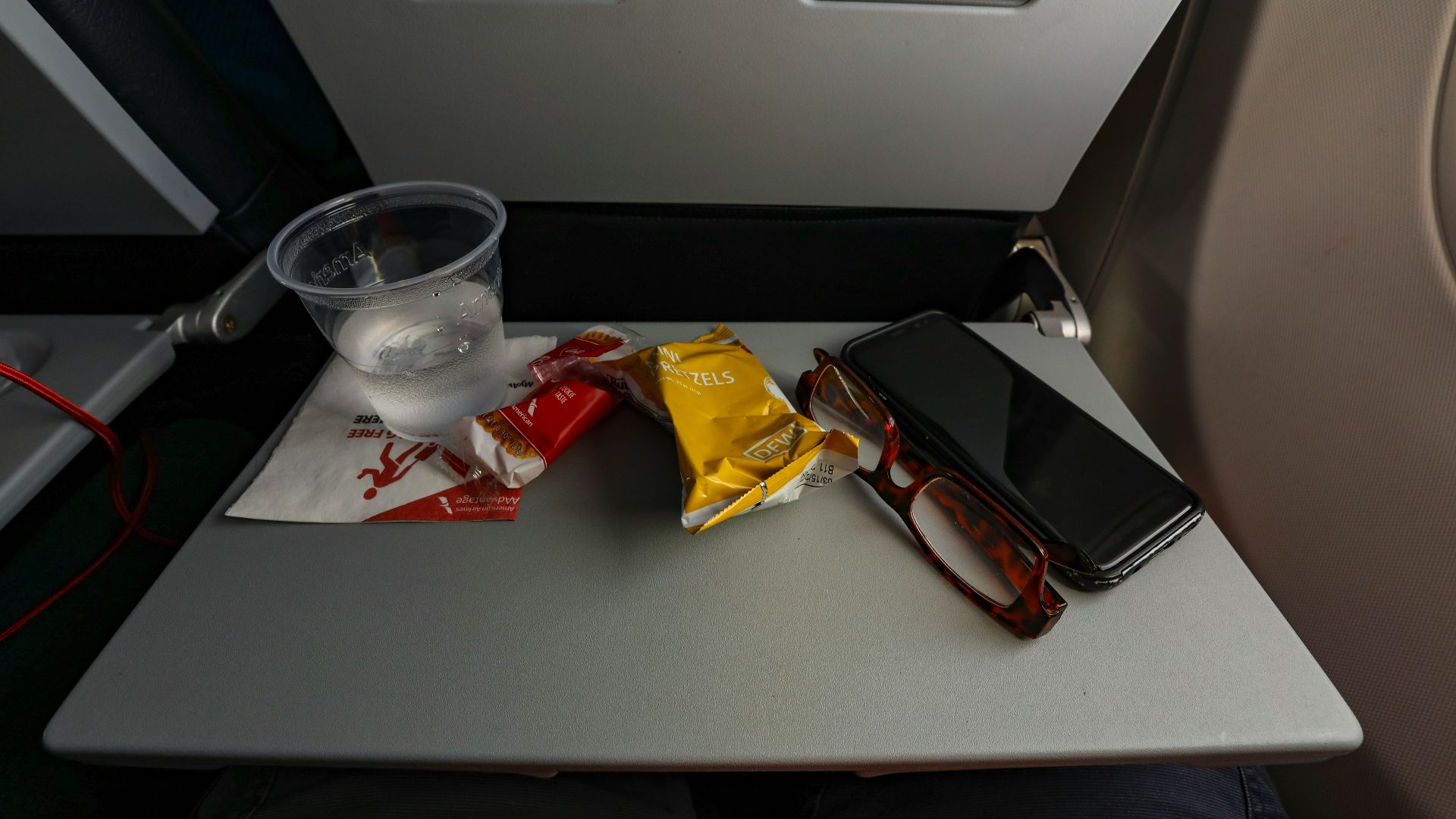 a table with a cell phone and some snacks on it