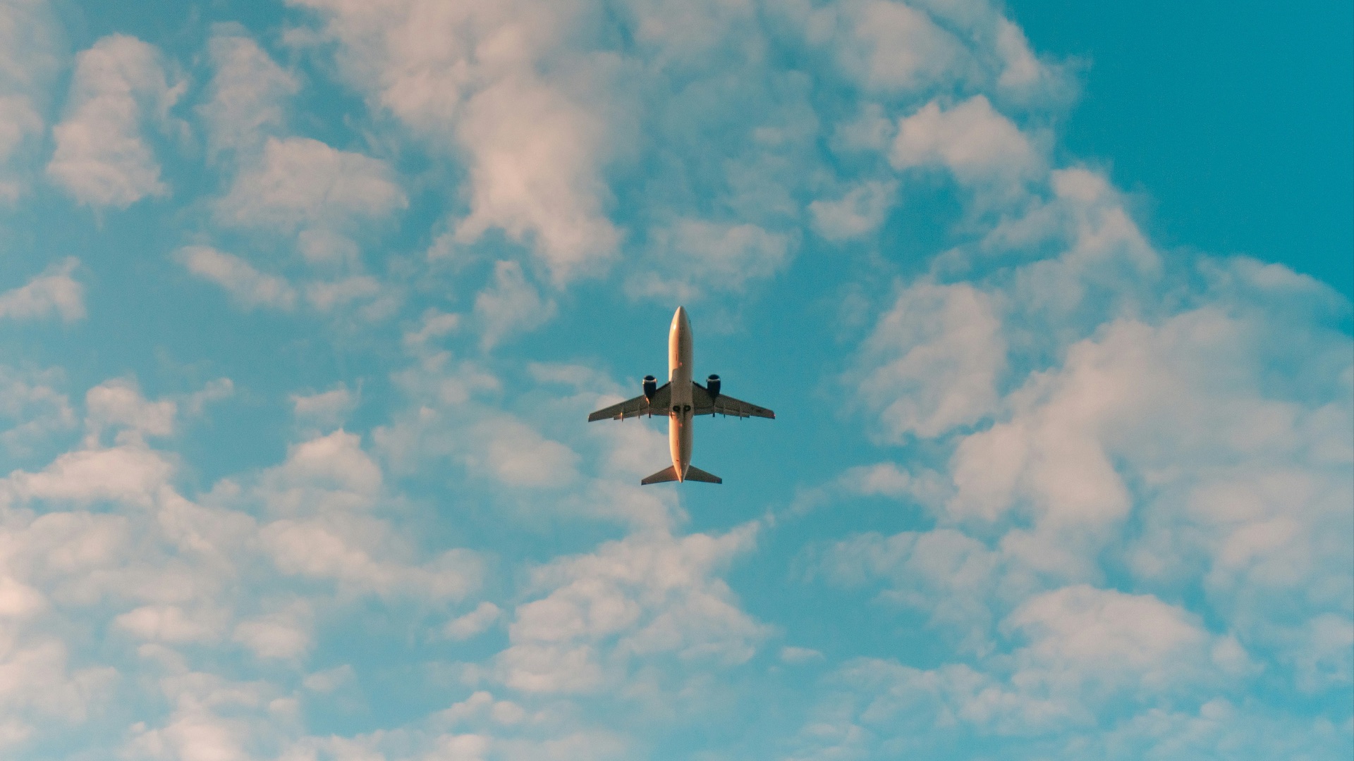 white airplane flying in the sky during daytime